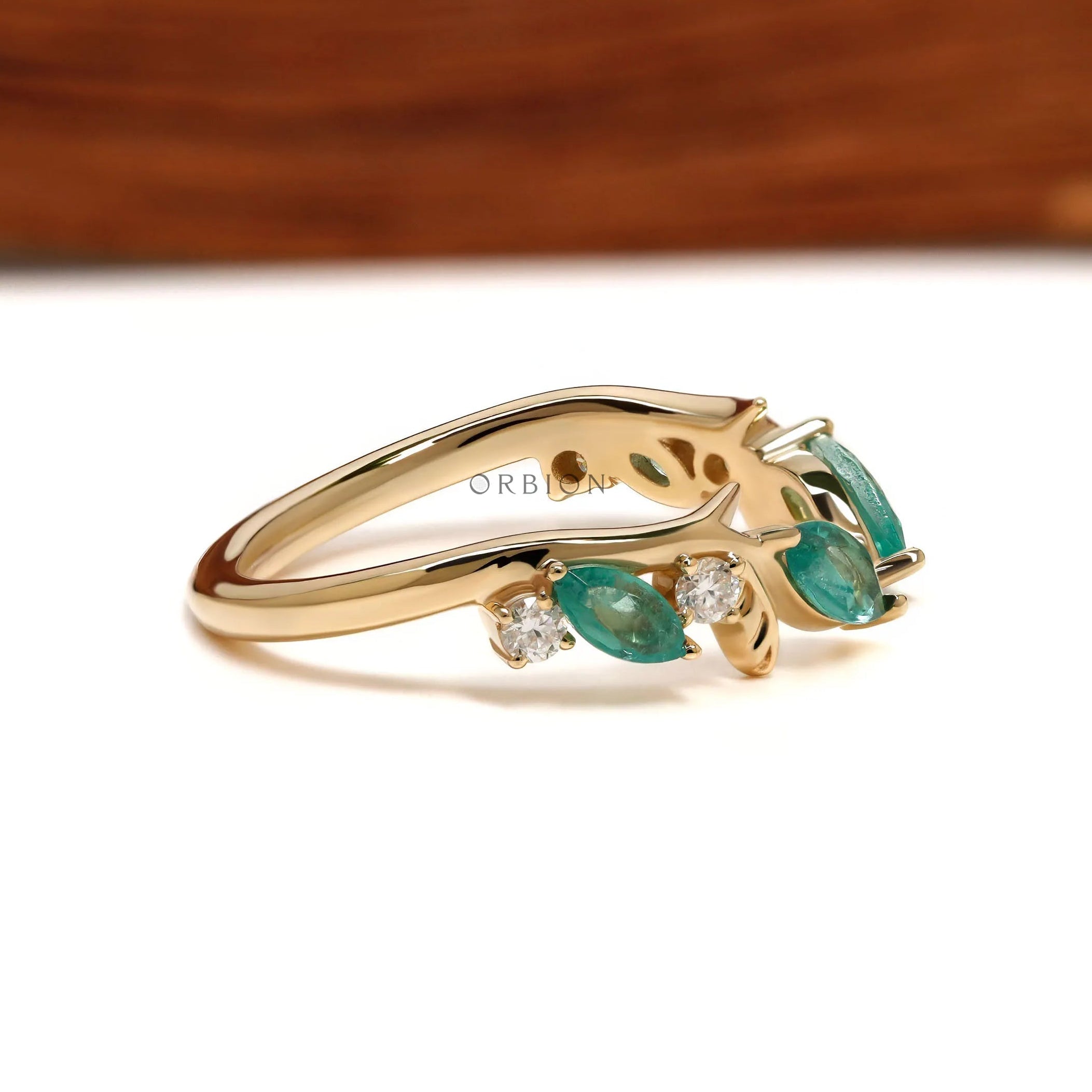 Minimalist leaf-inspired open cuff ring with green lab gemstones in 10k yellow gold for stacking