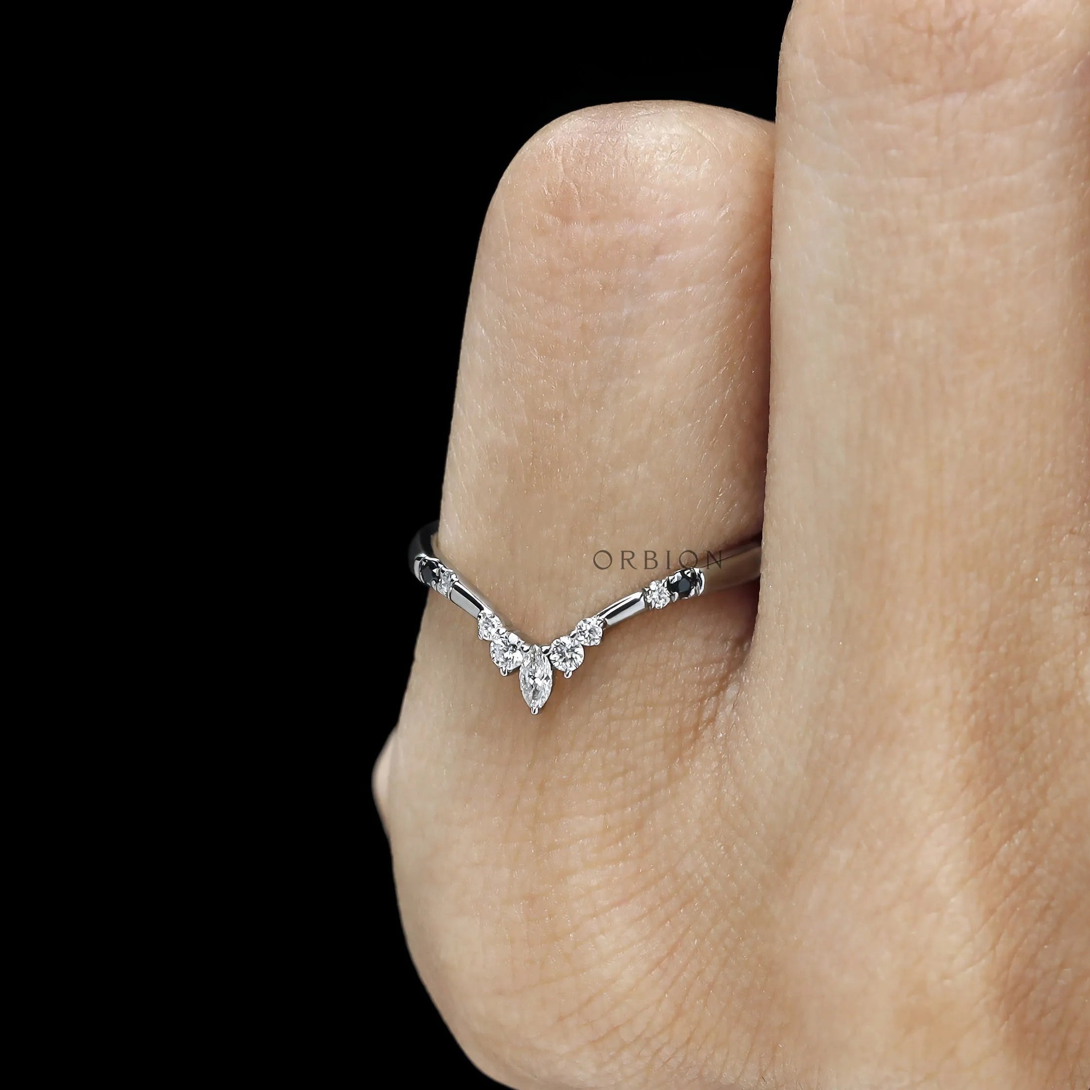 Minimal platinum stacking ring featuring black and white gemstones 
