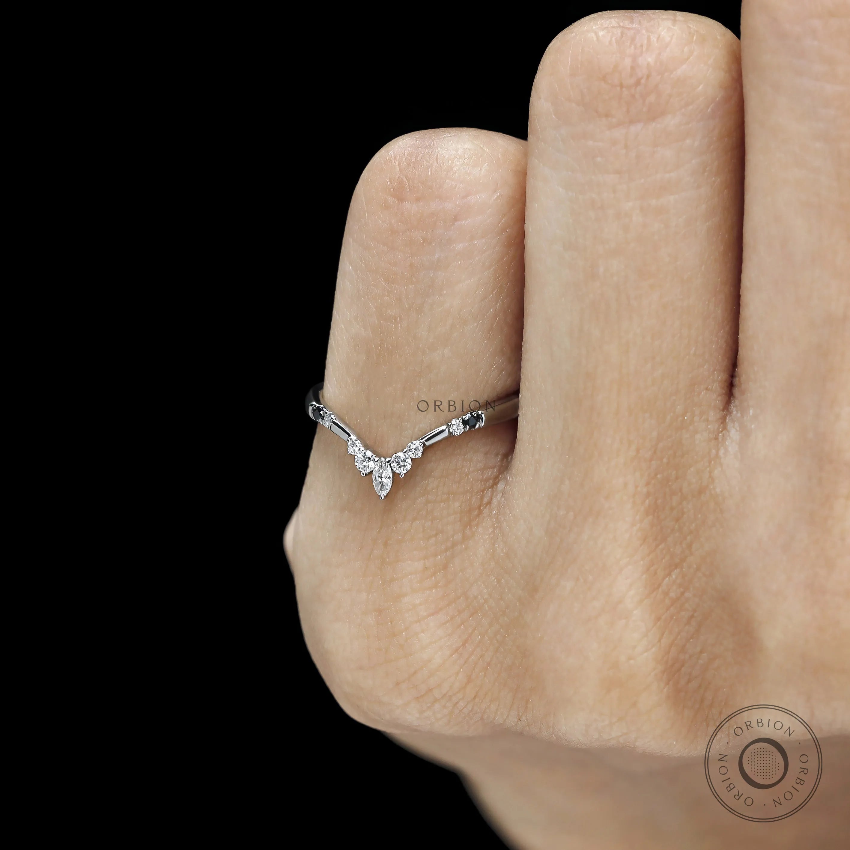 Minimal platinum stacking ring featuring black and white gemstones 