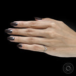 Modern platinum chevron band featuring black gemstones and white gemstone accents for bridal wear