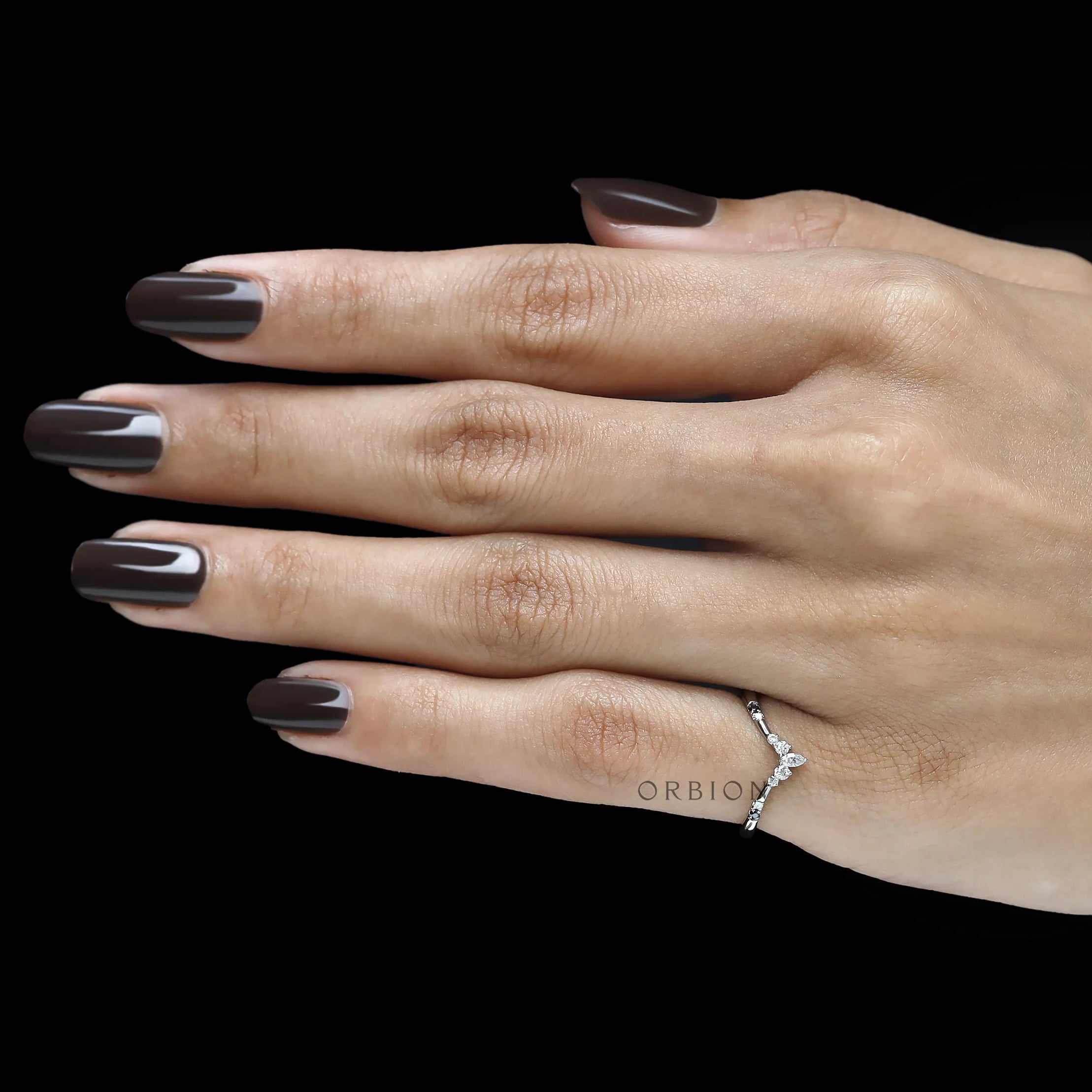 Modern platinum chevron band featuring black gemstones and white gemstone accents for bridal wear
