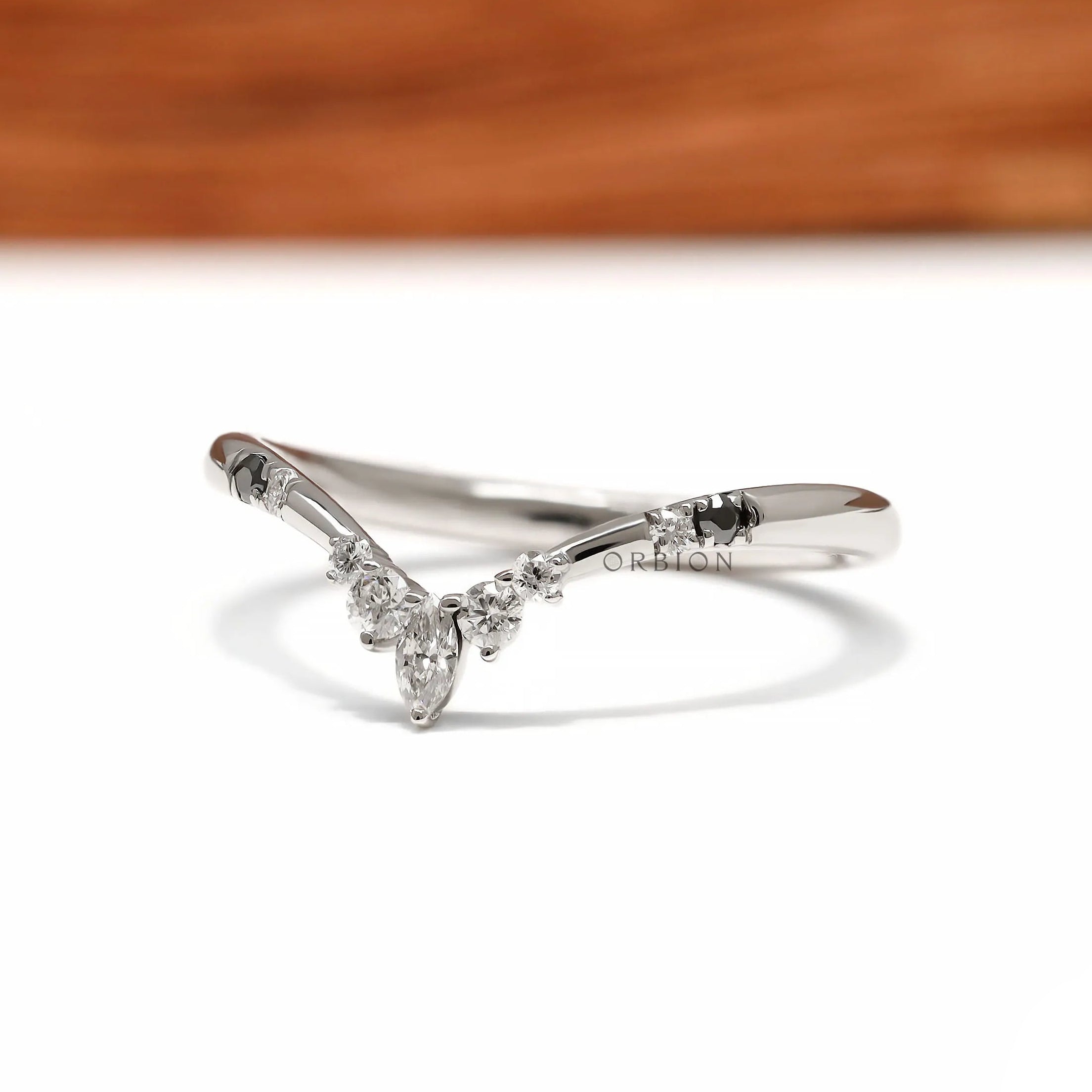 V shaped wishbone wedding band in platinum with black and white gemstone detailing for stacking