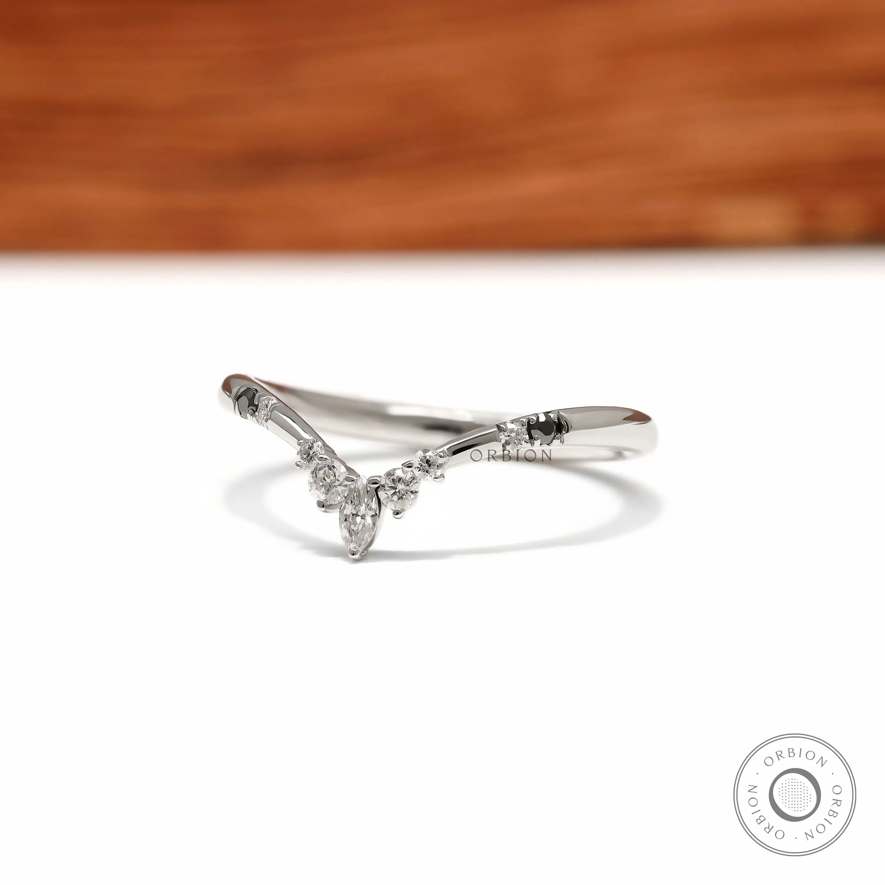 V shaped wishbone wedding band in platinum with black and white gemstone detailing for stacking