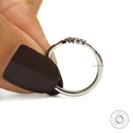 Platinum wedding band with black and white gemstones in a delicate chevron V shaped design