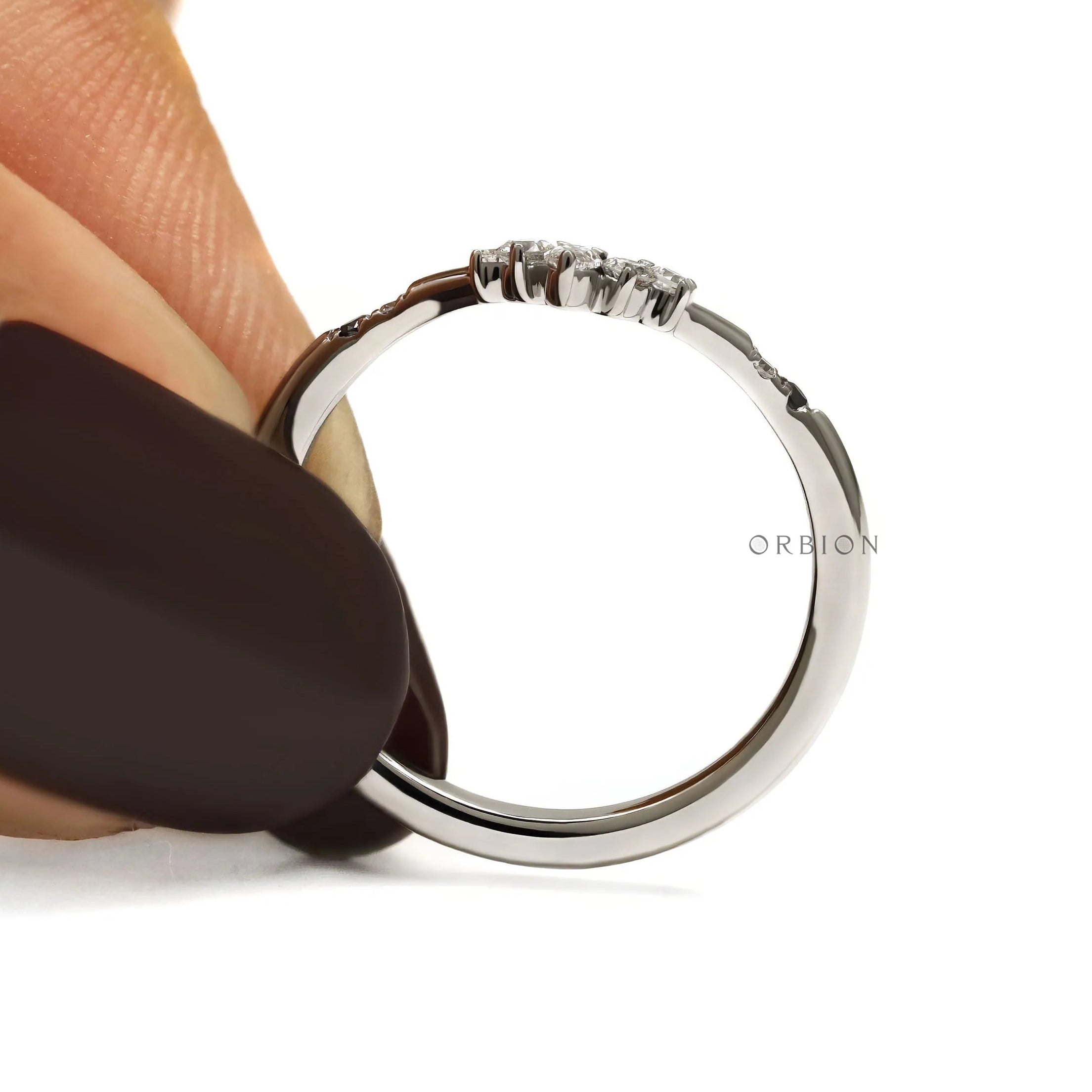 Platinum wedding band with black and white gemstones in a delicate chevron V shaped design