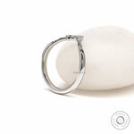 Minimalist platinum wishbone stacking ring with curved V shape and unique gemstone accents