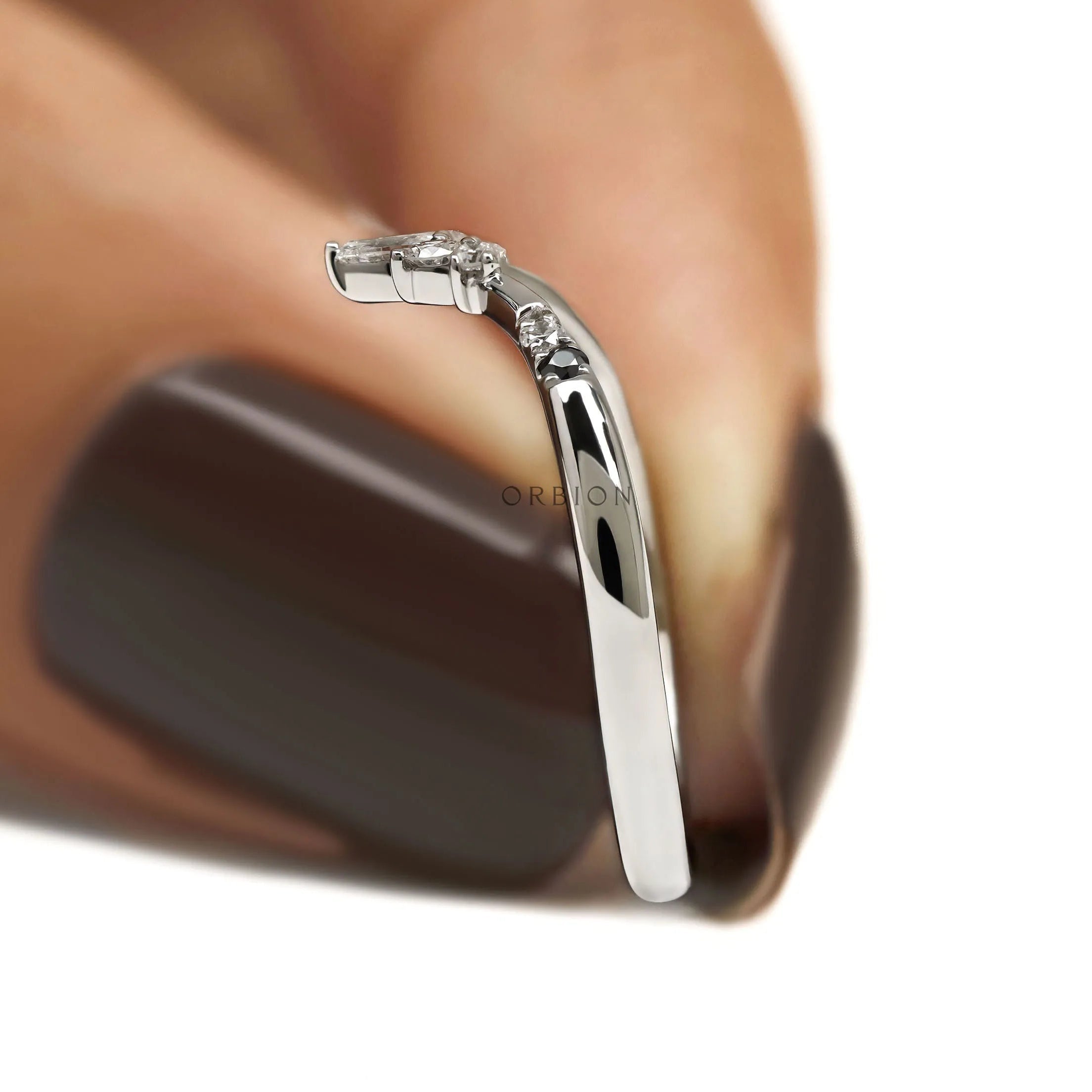 Dainty V shaped platinum stacking ring with contrasting gemstones for engagement ring pairing