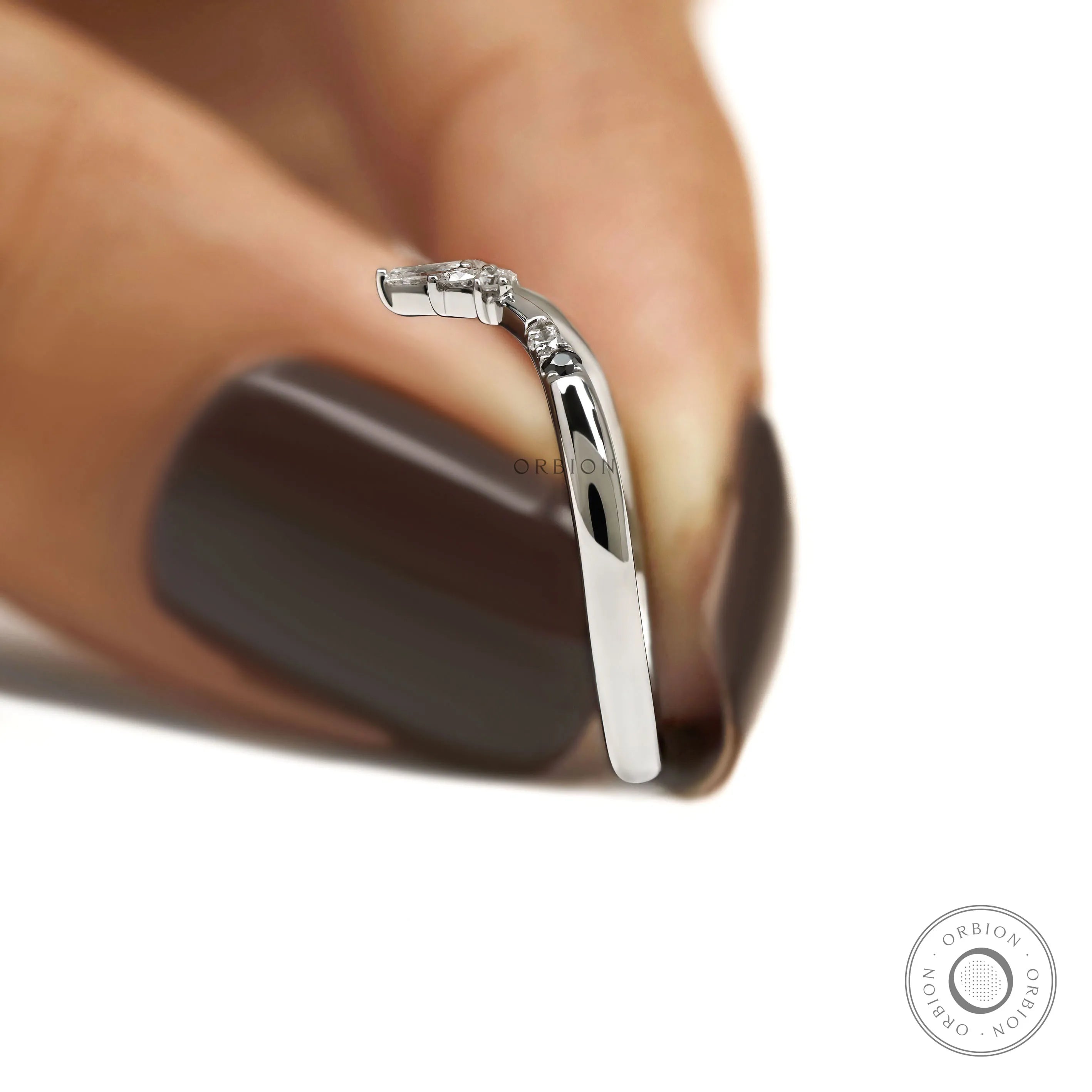 Dainty V shaped platinum stacking ring with contrasting gemstones for engagement ring pairing