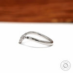 Elegant platinum chevron ring featuring black and white gemstones, perfect as a bridal stacking band