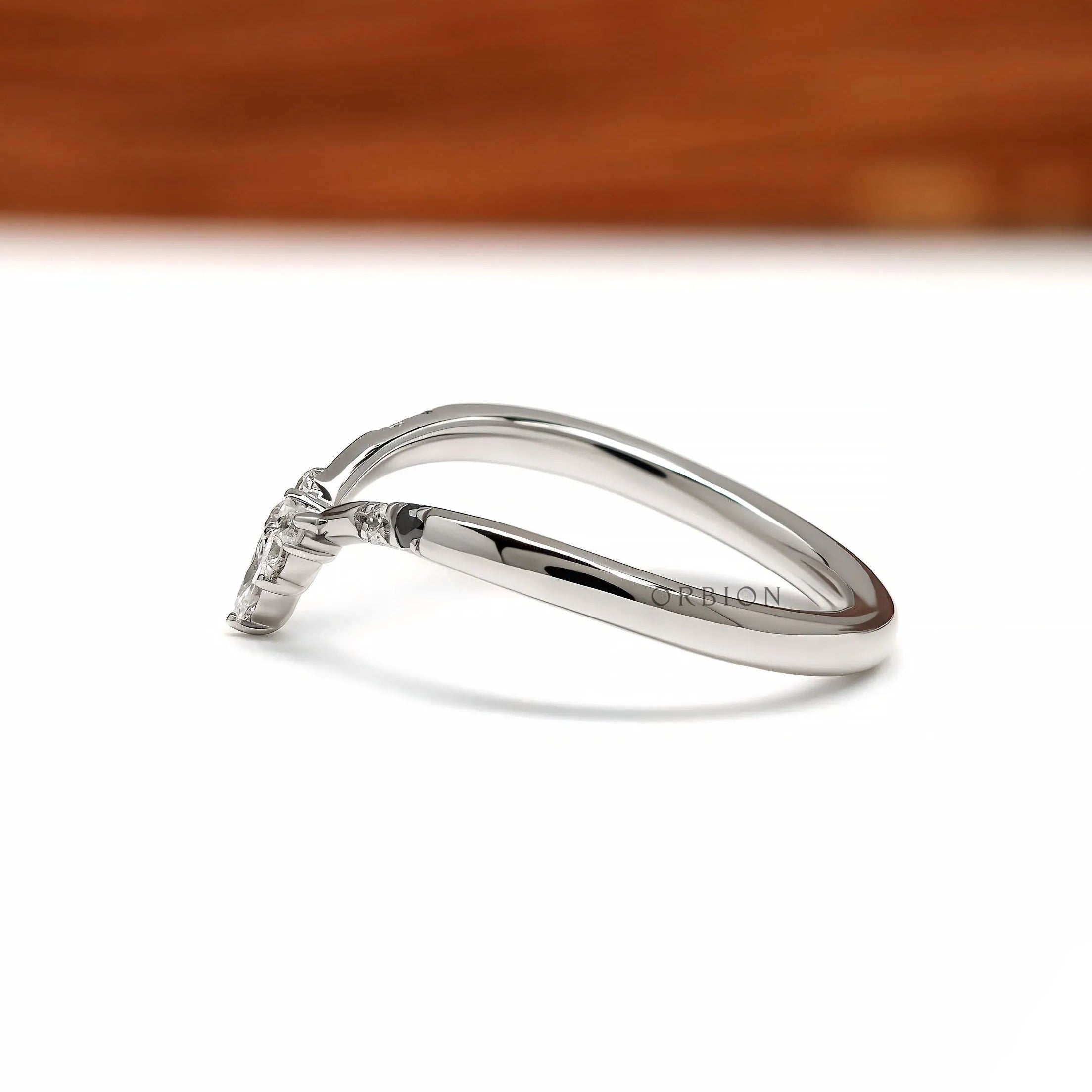 Elegant platinum chevron ring featuring black and white gemstones, perfect as a bridal stacking band