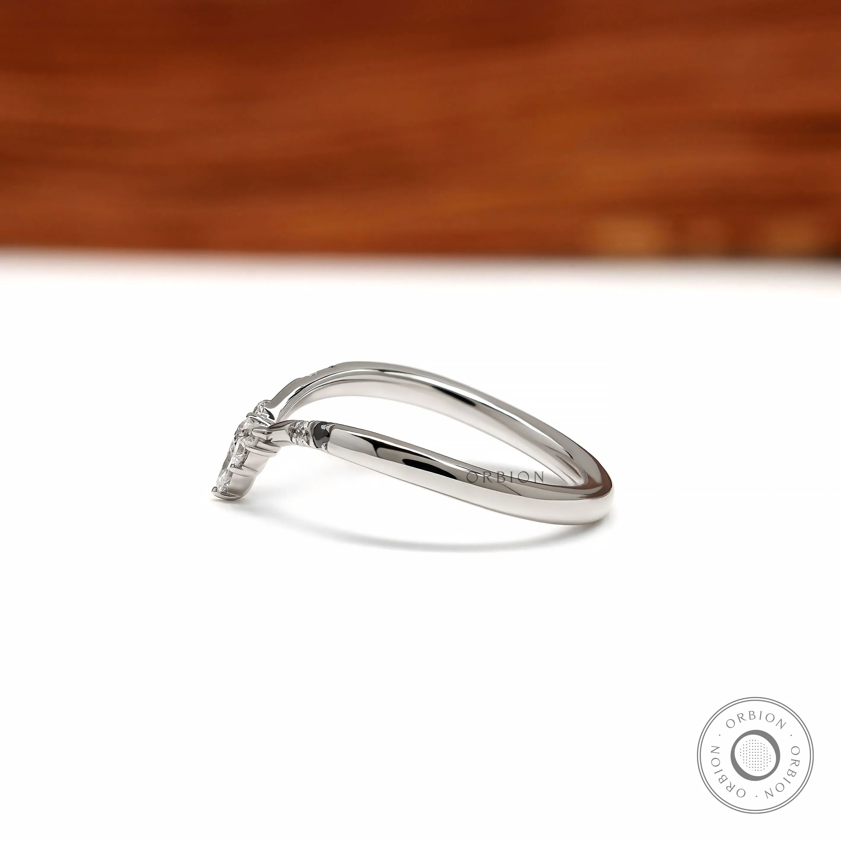 Elegant platinum chevron ring featuring black and white gemstones, perfect as a bridal stacking band