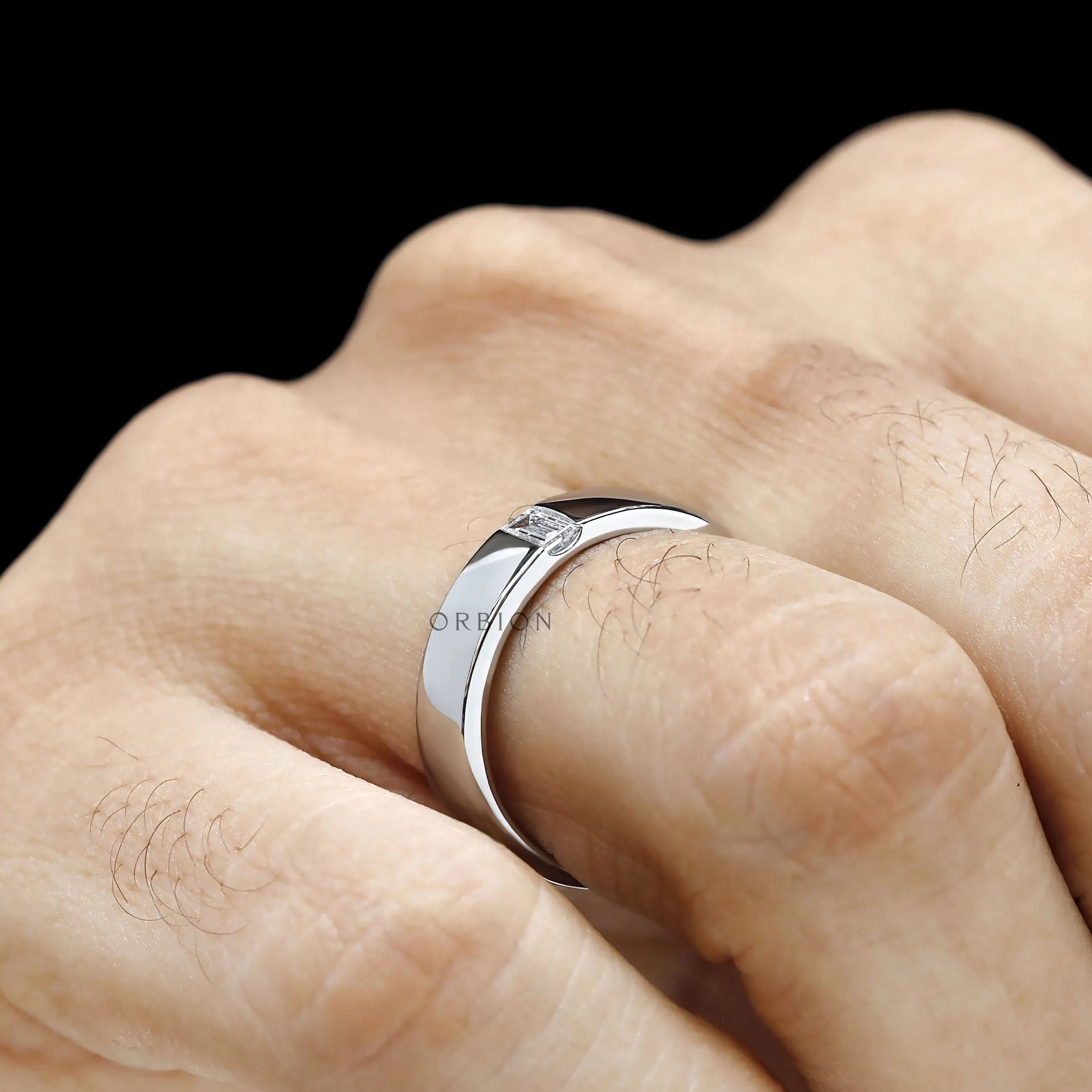 Classic men’s diamond ring featuring baguette cut stone and platinum wedding band 