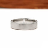 Modern men’s anniversary band featuring platinum, baguette cut diamond and matte finish