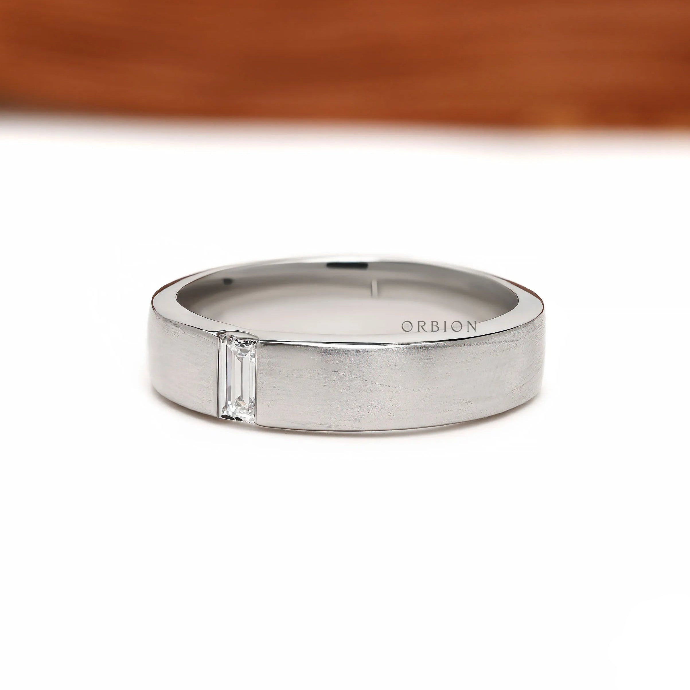 5 mm wide men’s platinum wedding ring with baguette diamonds, brushed matte texture