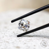 Cushion Peruzzi cut moissanite held in tweezers