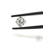 Loose cushion moissanite placed on neutral surface