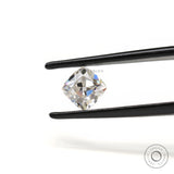 Loose cushion moissanite placed on neutral surface