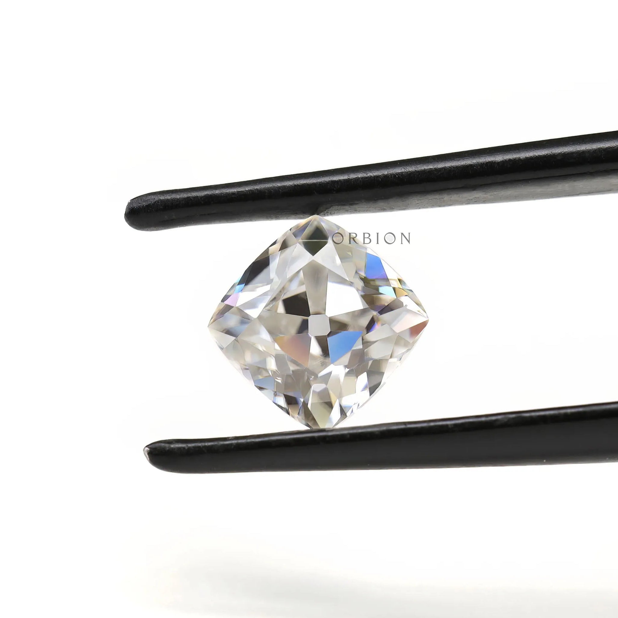 Loose cushion moissanite placed on neutral surface