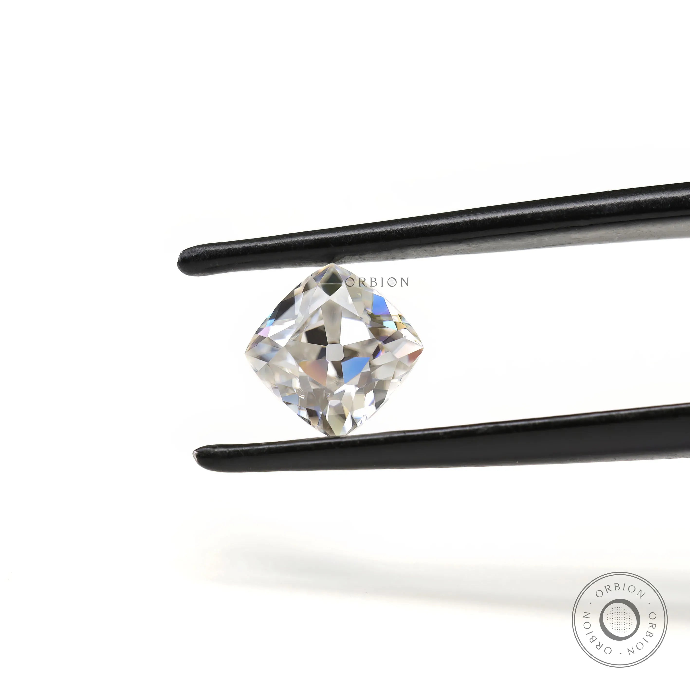 Loose cushion moissanite placed on neutral surface