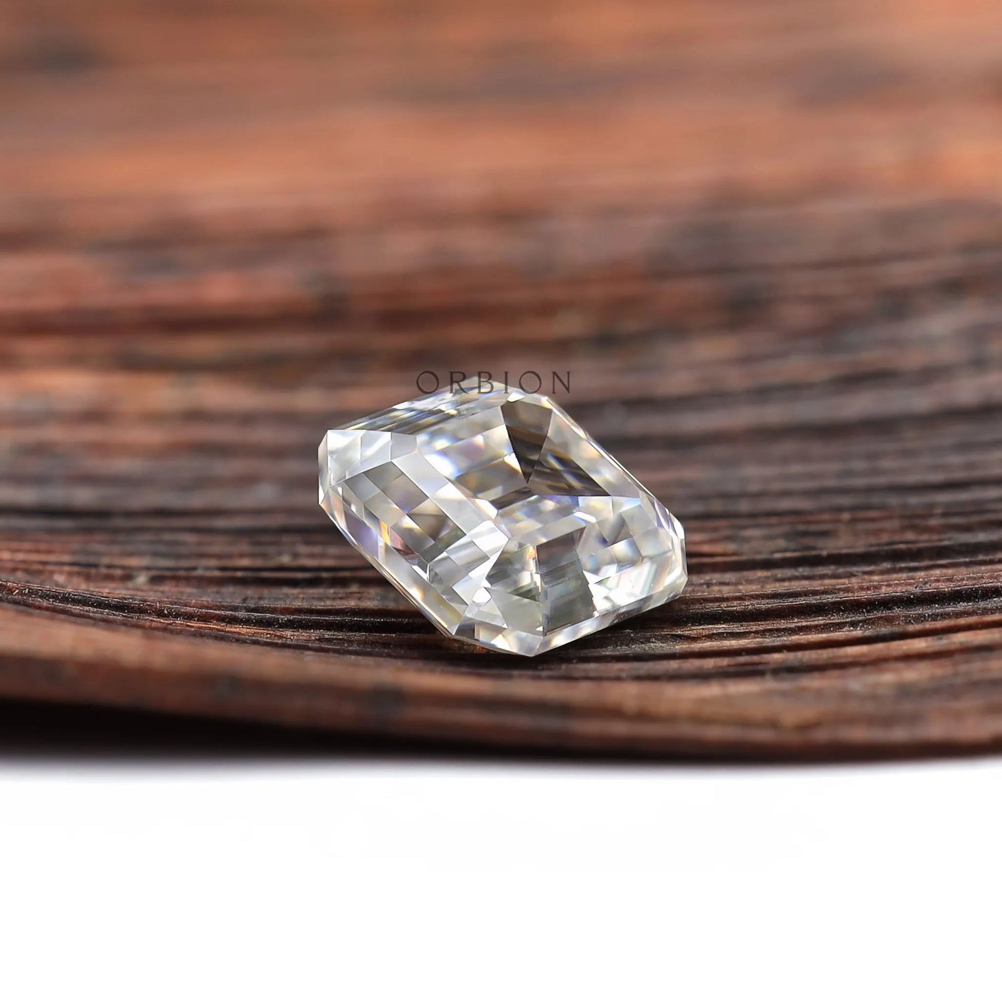 Elongated asscher moissanite gemstone with antique old mine style cut