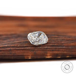 elongated cushion moissanite sparkle on wooden surface