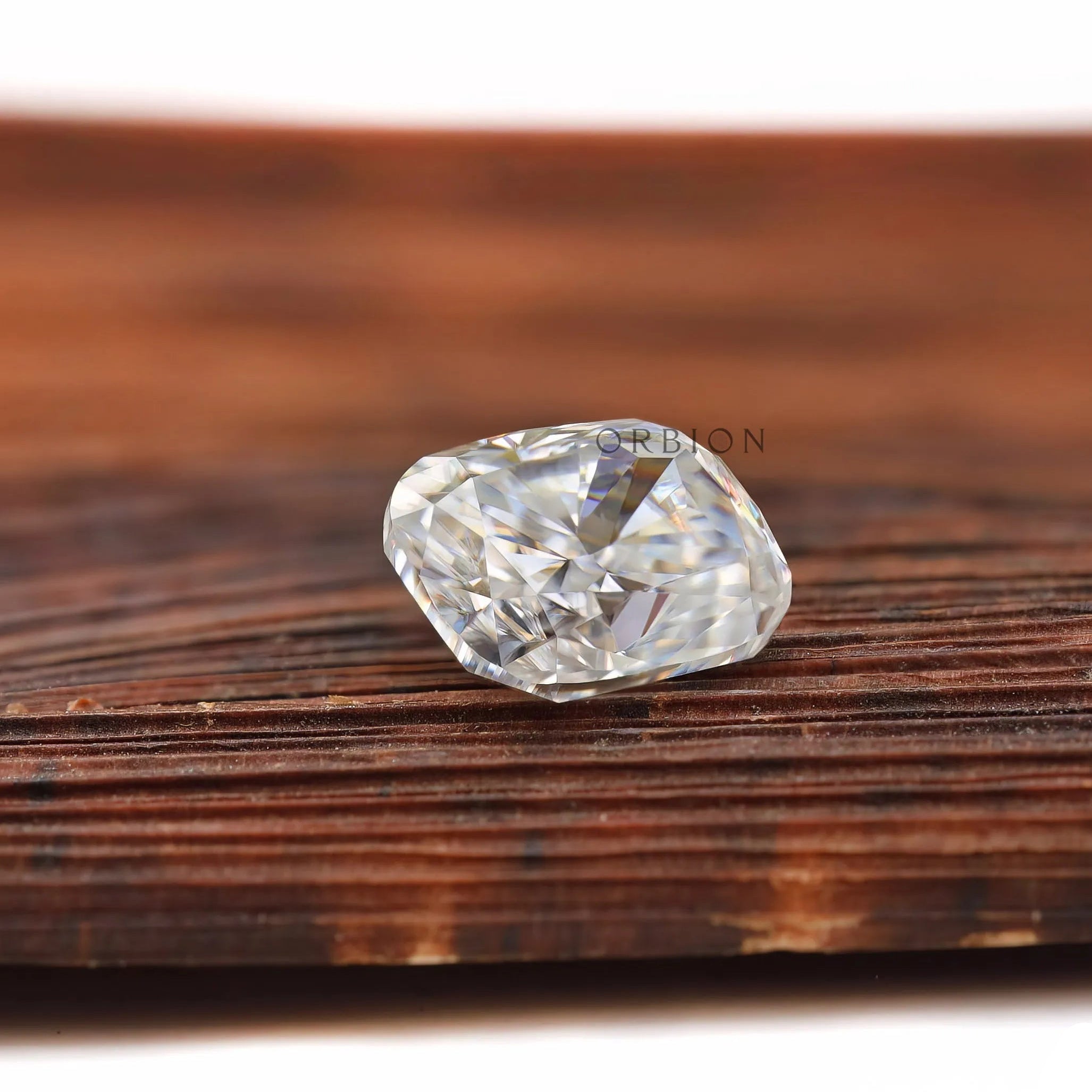 elongated cushion moissanite sparkle on wooden surface
