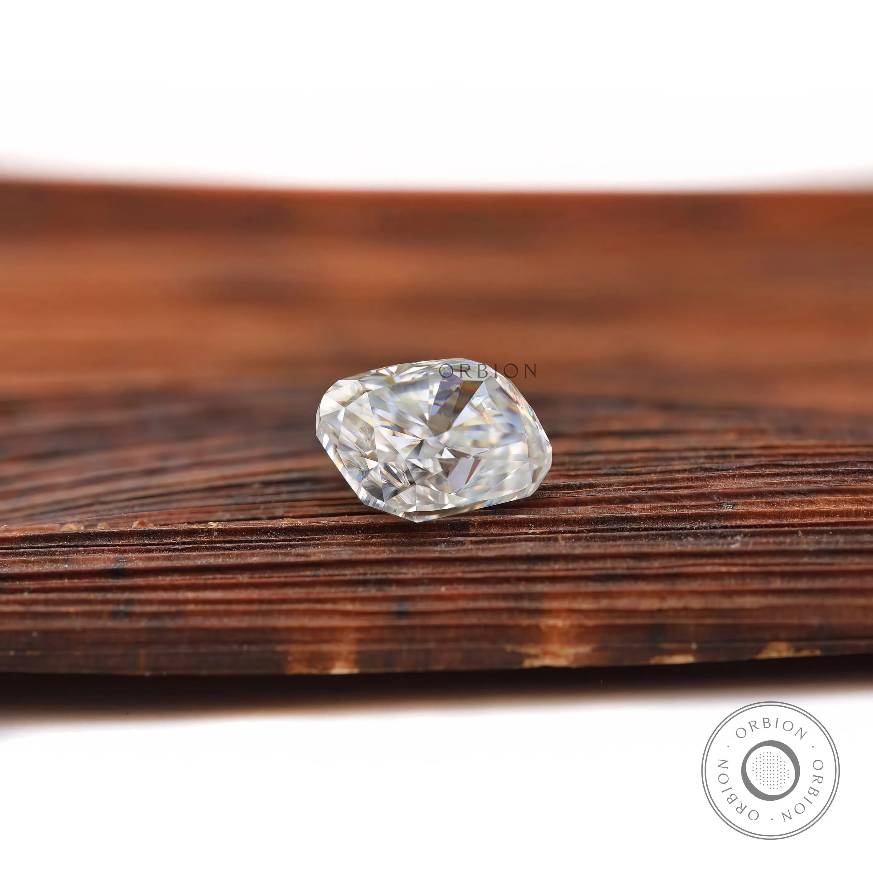 elongated cushion moissanite sparkle on wooden surface