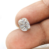 elongated cushion moissanite held on fingertip close view