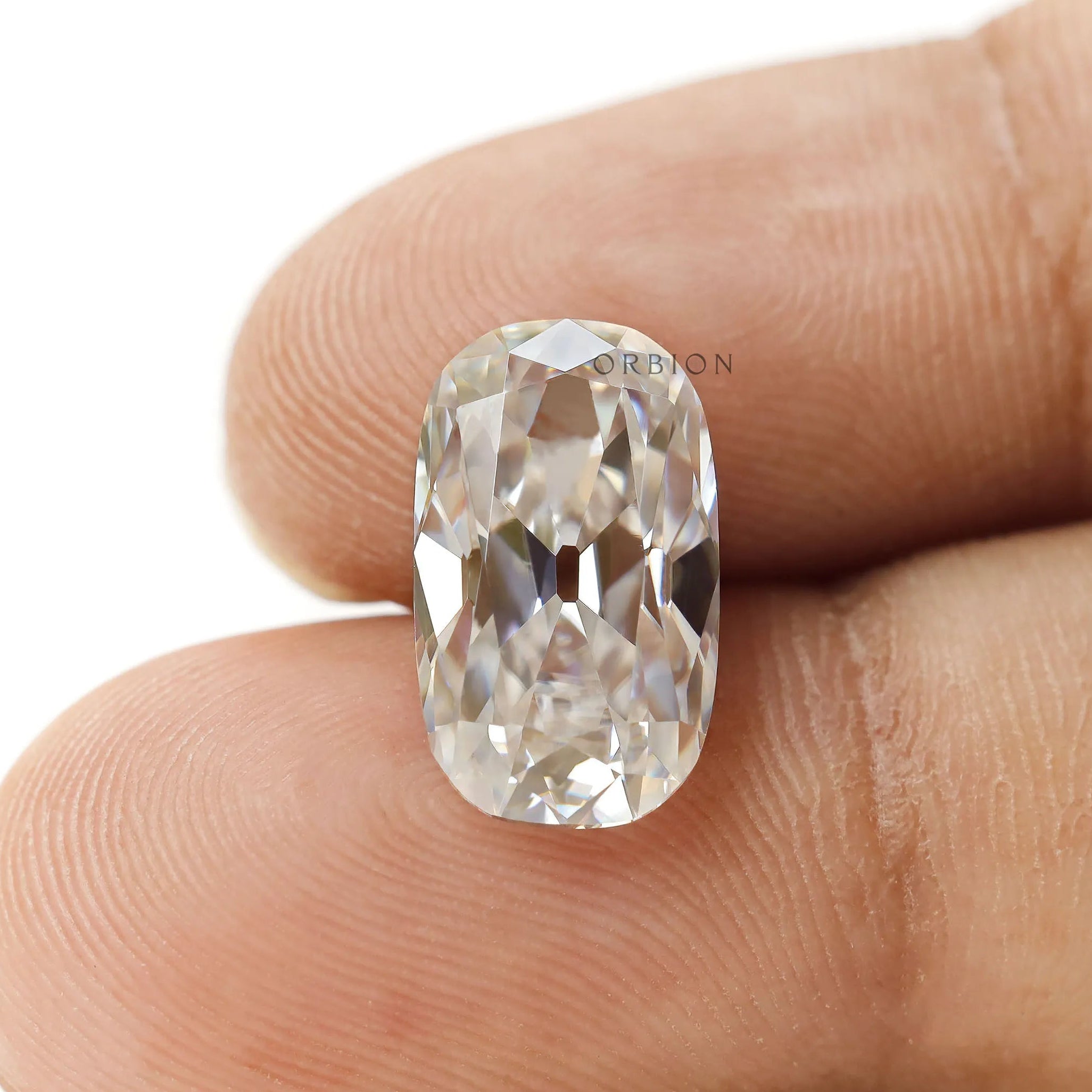 Elongated cushion old mine cut moissanite in colorless hue