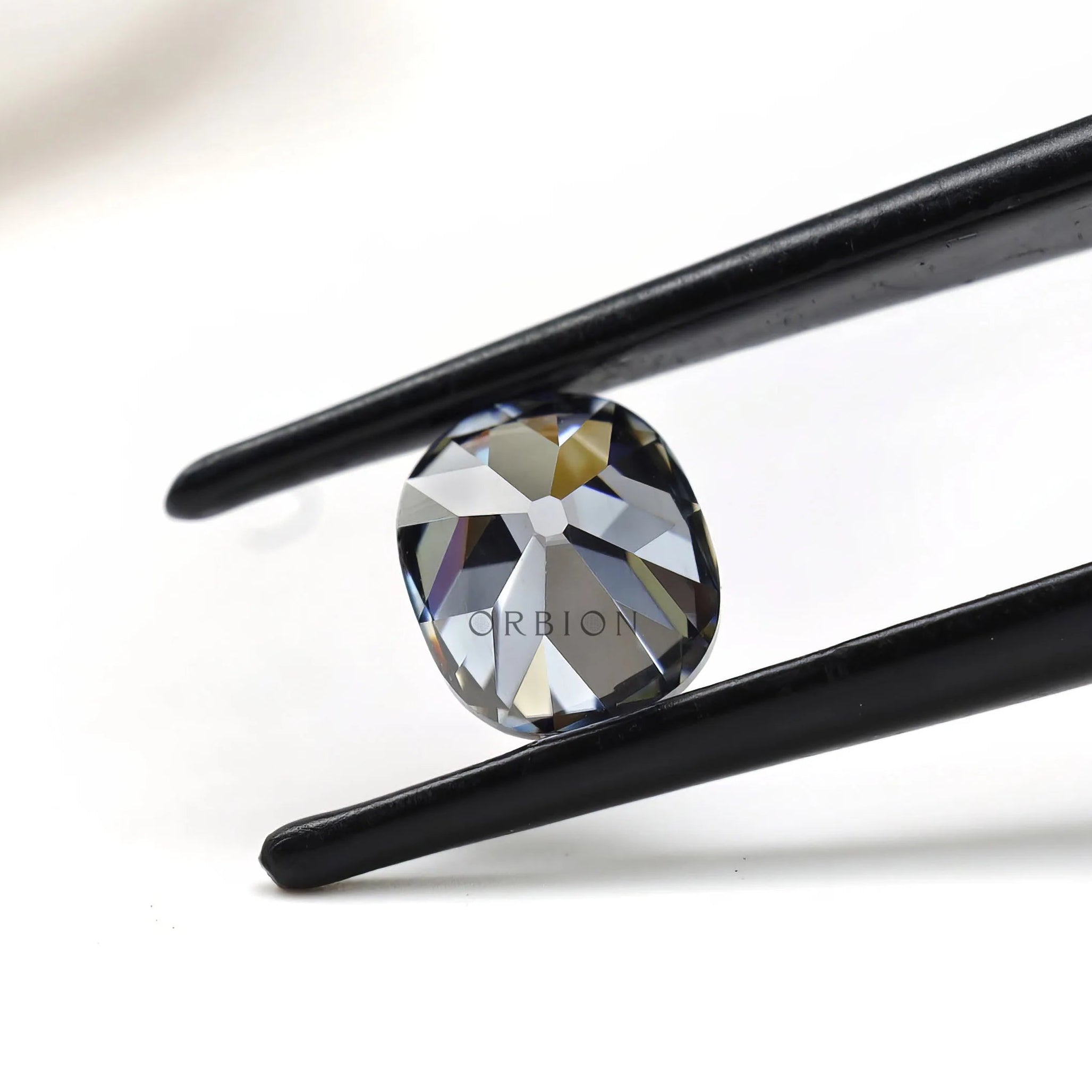 Elongated cushion moissanite 1.20 ct in deep grey tone old mine faceting
