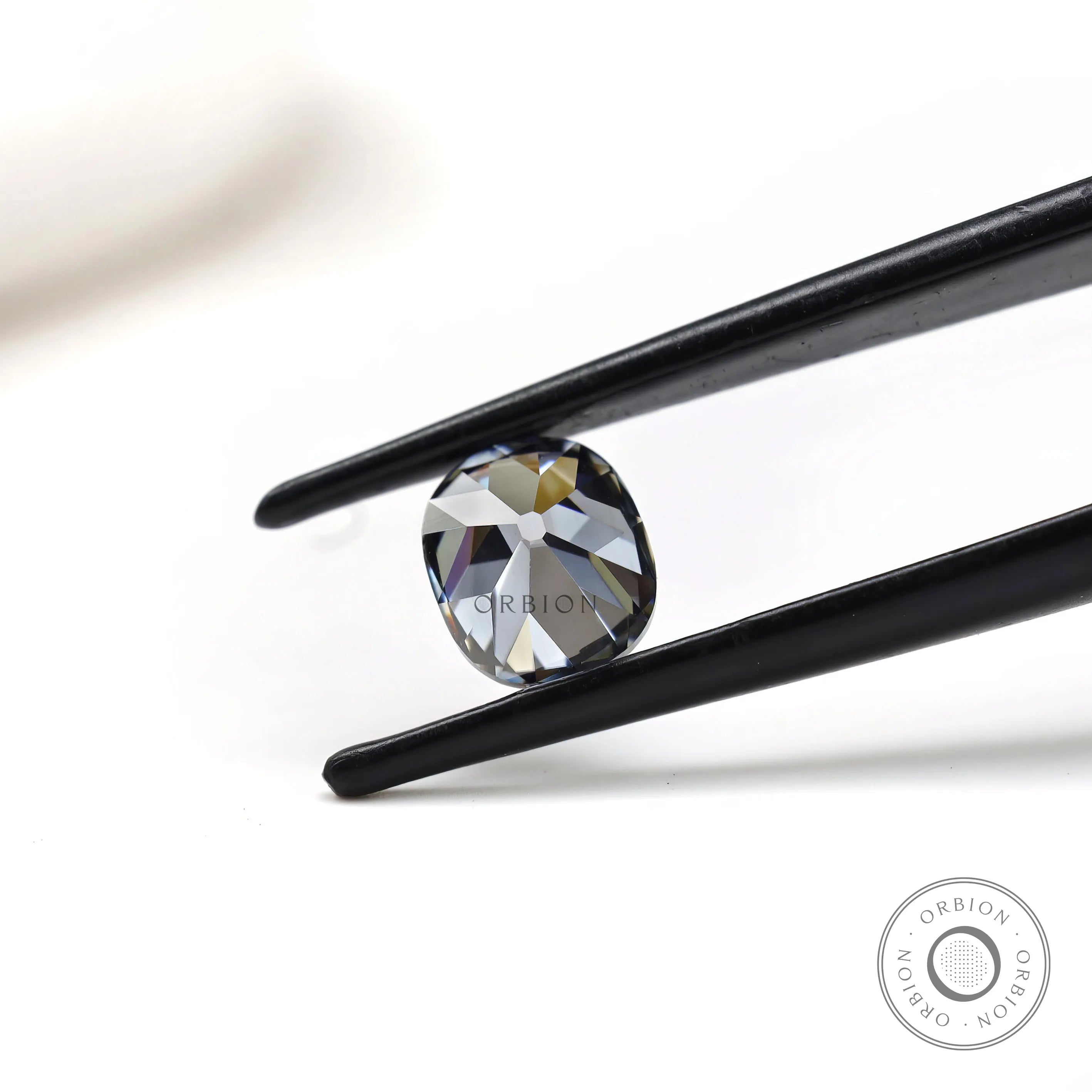 Elongated cushion moissanite 1.20 ct in deep grey tone old mine faceting