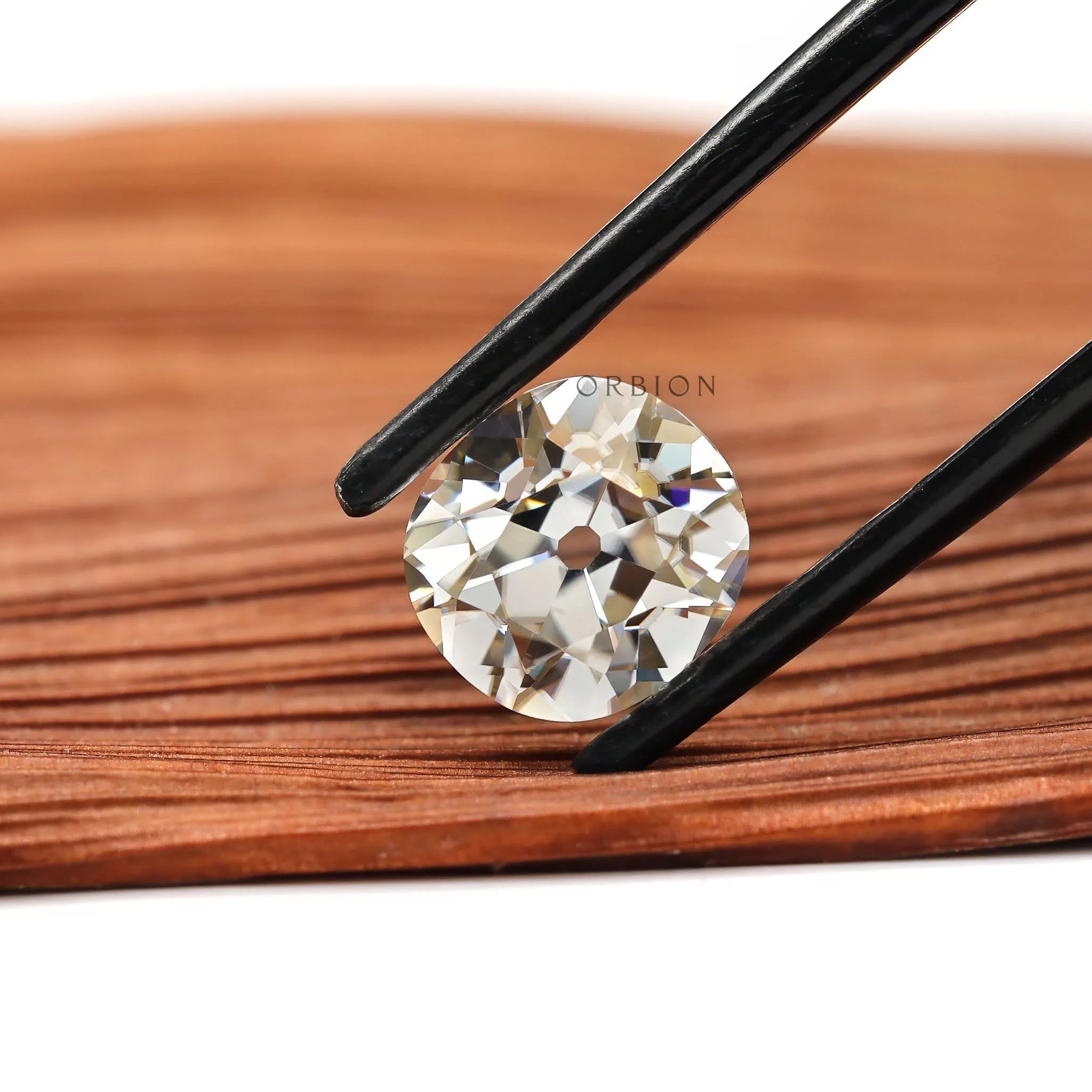 Loose elongated cushion gemstone with warm tint and antique finish