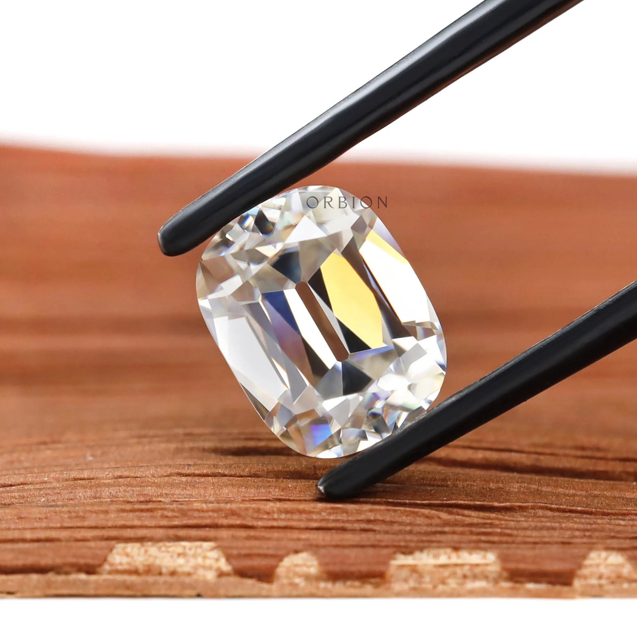 Moissanite Elongated Cushion Stone Old Mine Cut GHI Color VVS Clarity Held by Tweezers