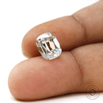 Moissanite Elongated Cushion Stone Held Between Fingers for Scale