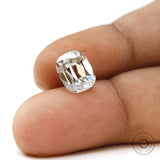 Moissanite Elongated Cushion Stone Held Between Fingers for Scale