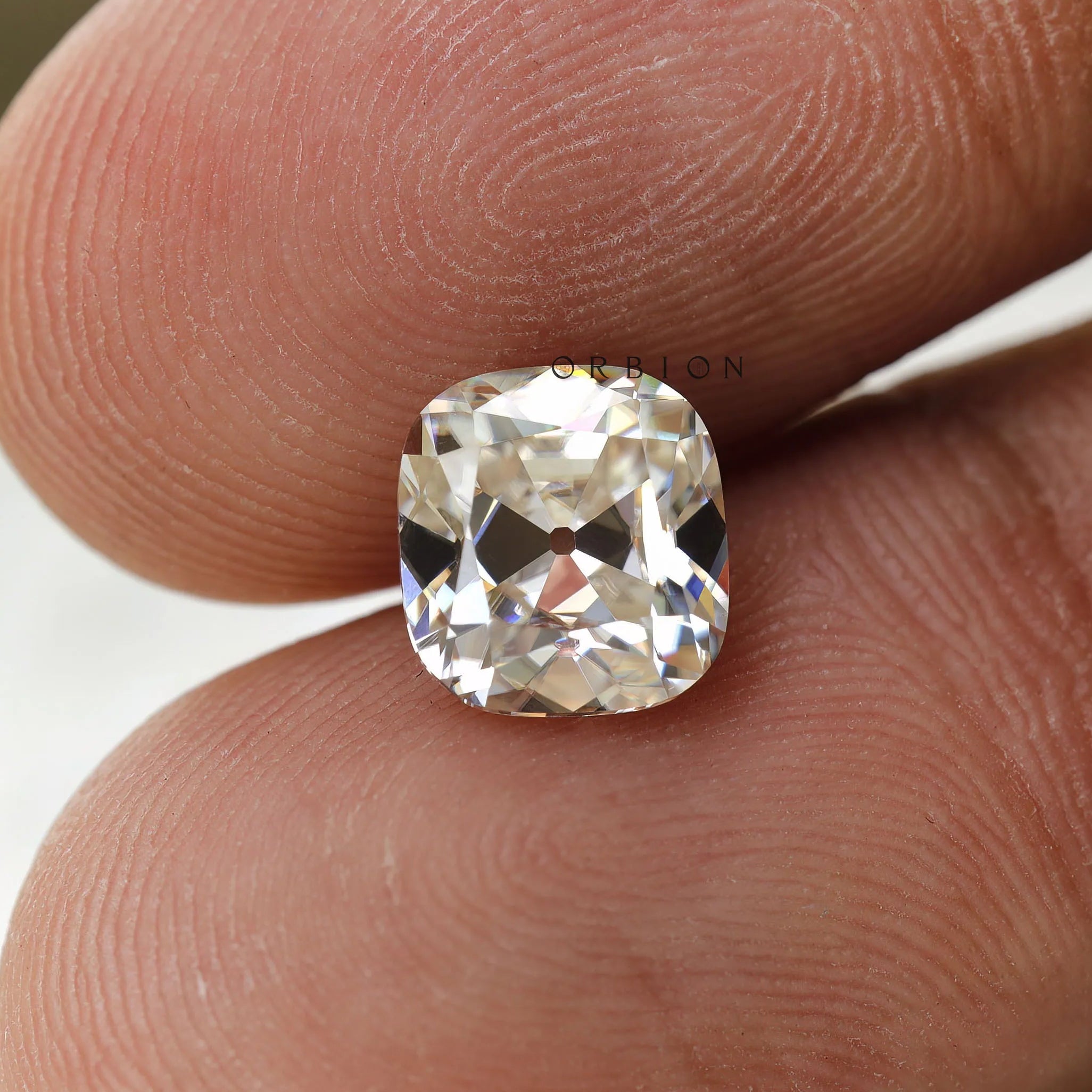 Loose 3 CT cushion moissanite in off white tone with old mine faceting