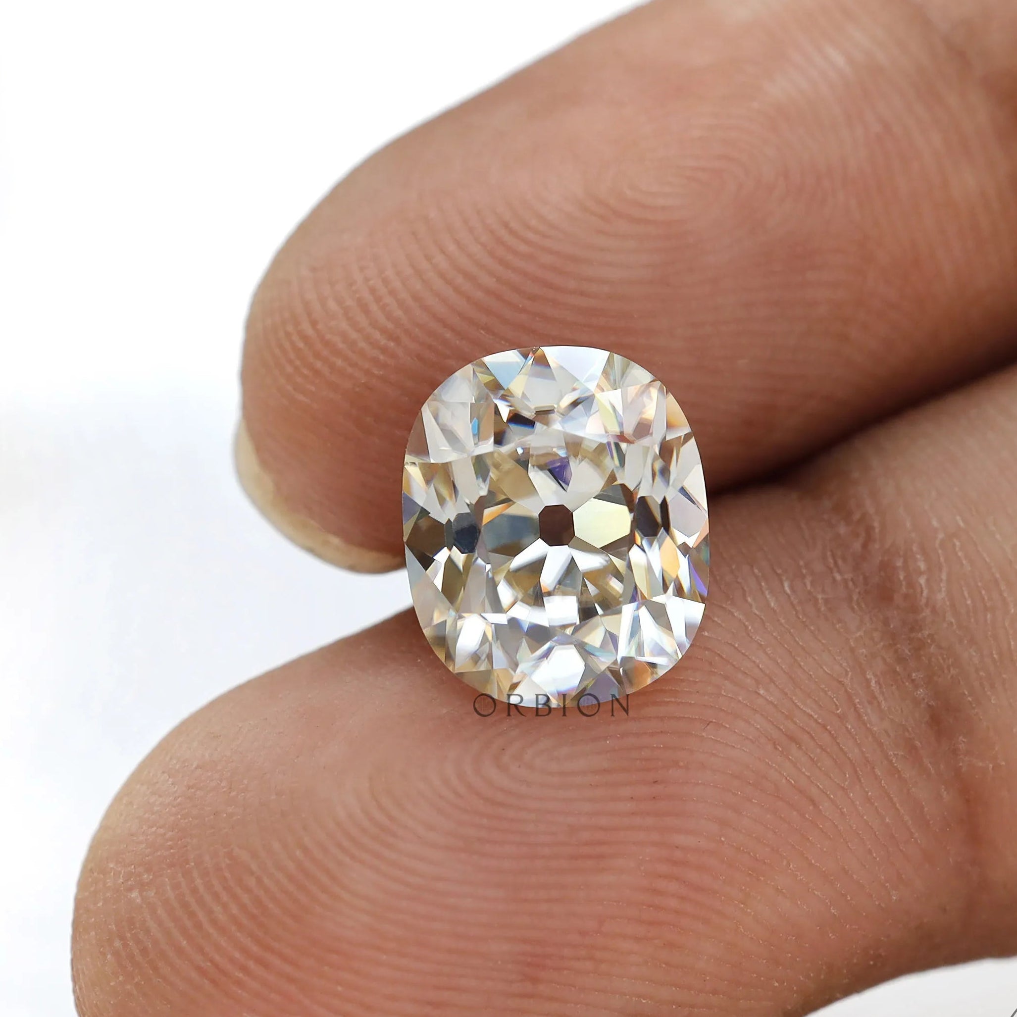 3 ct elongated cushion moissanite off white tone with old mine faceting