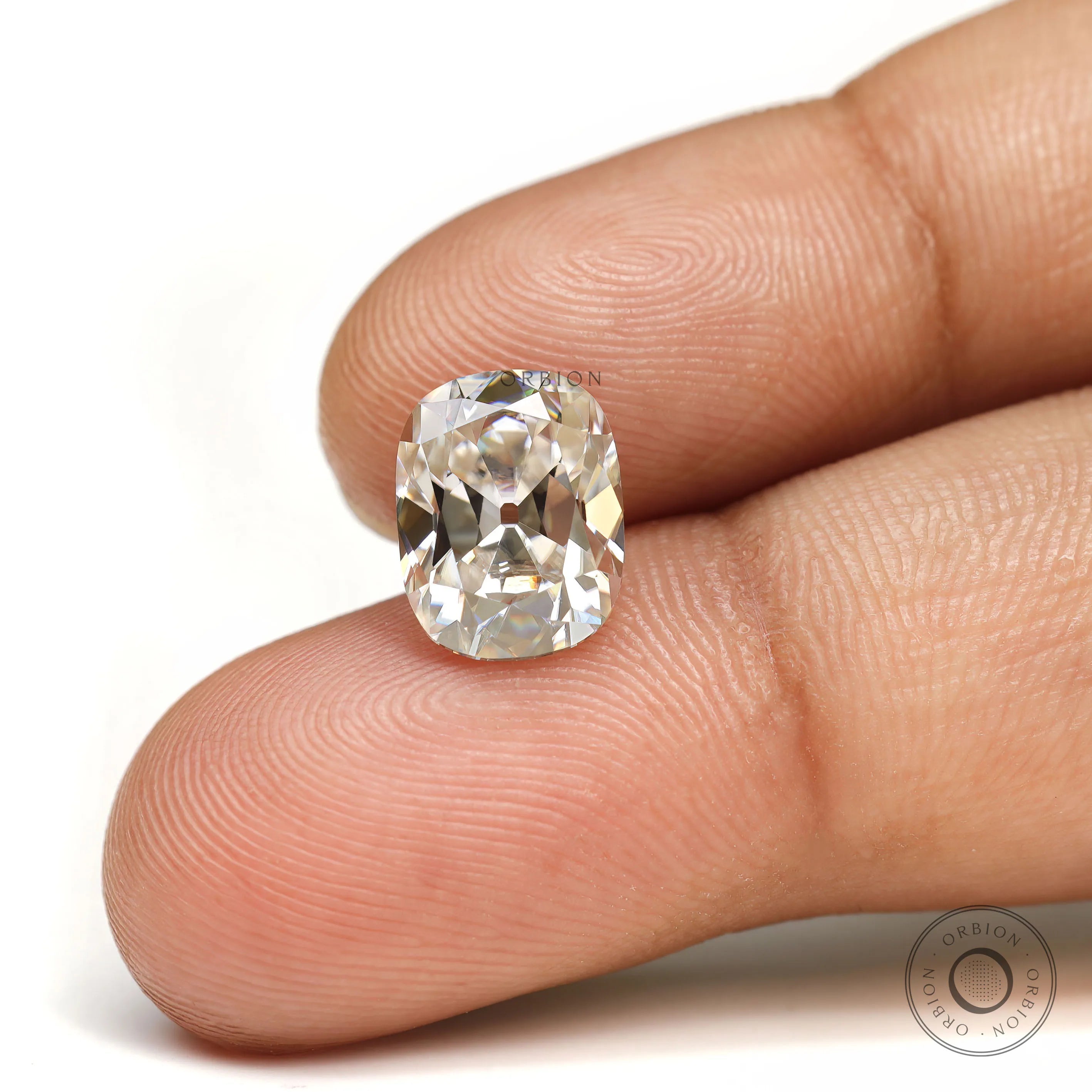 Elongated cushion moissanite off white color with antique cut detail