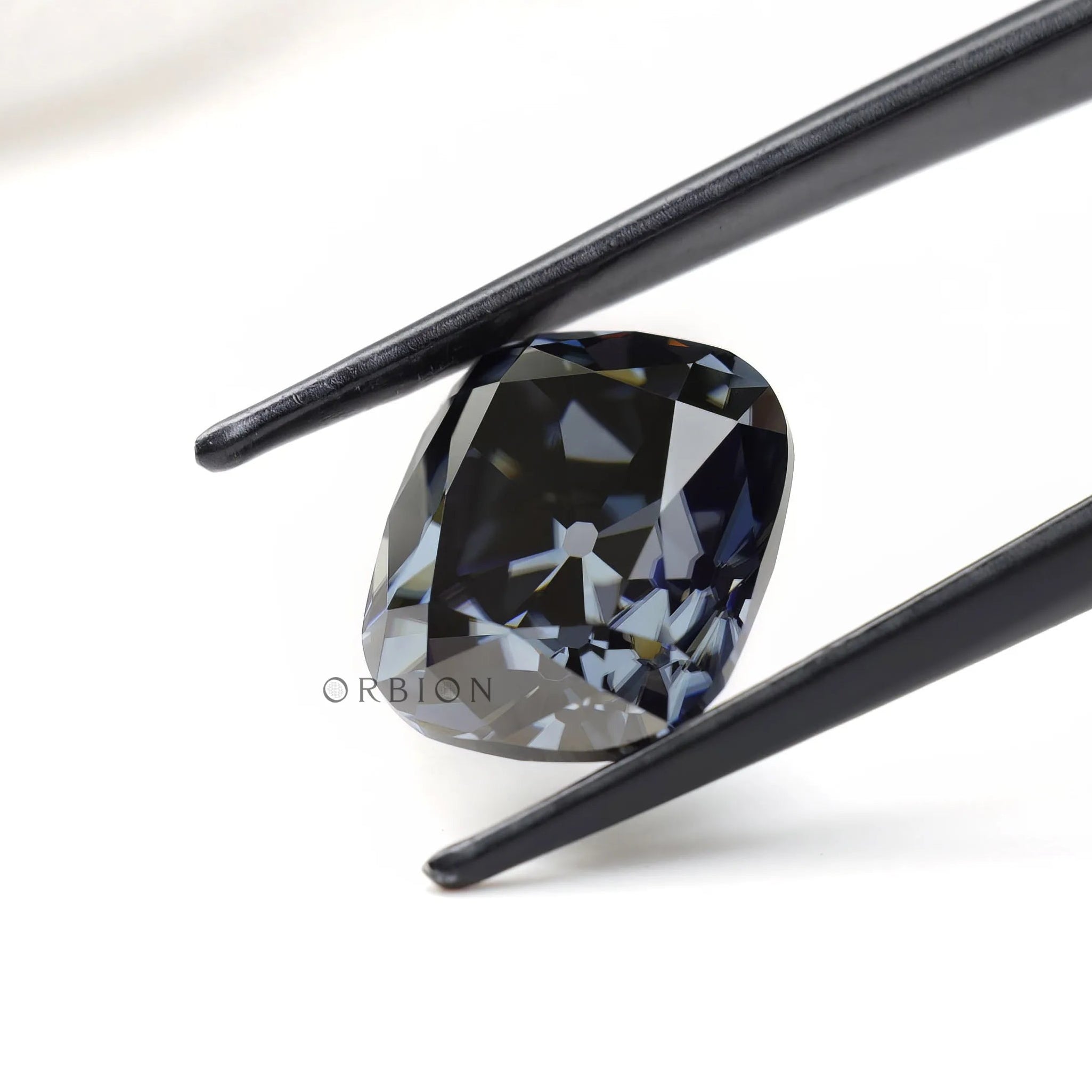 Elongated cushion moissanite with smoky grey hue and antique finish