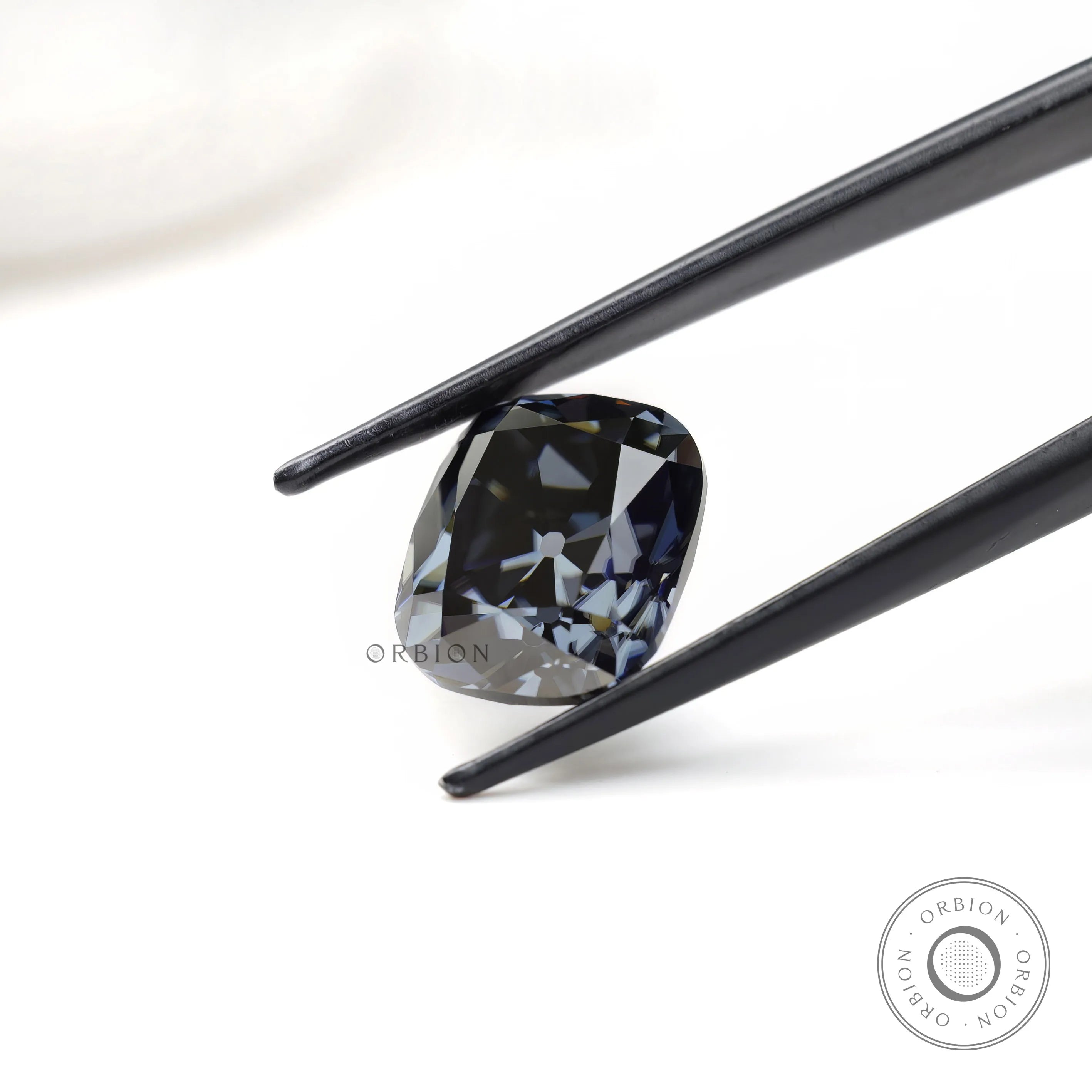 Elongated cushion moissanite with smoky grey hue and antique finish