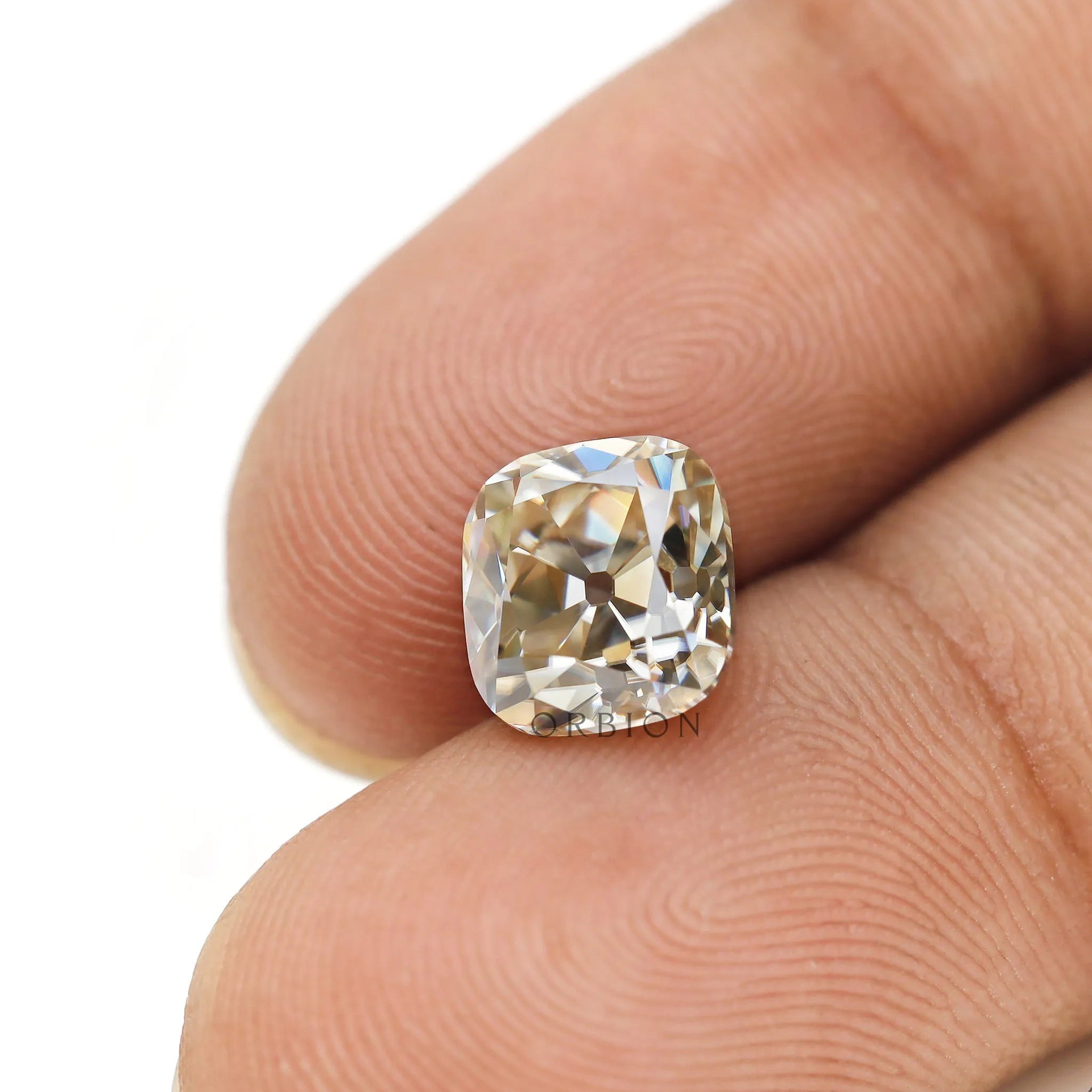Elongated cushion old mine cut warm color moissanite