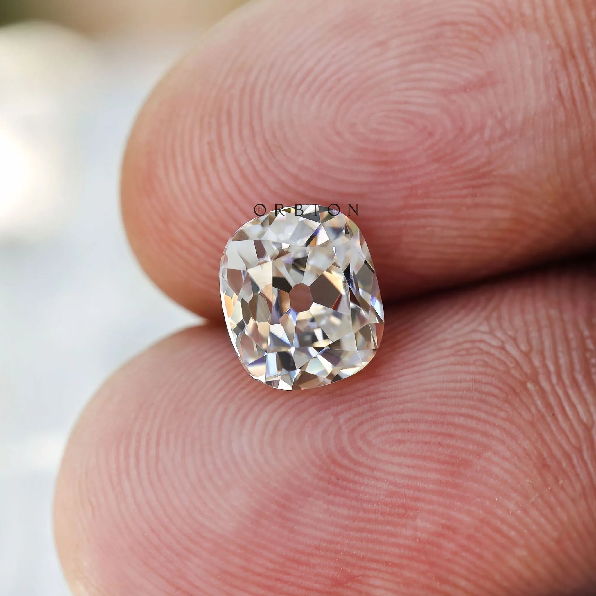 1.20 ct Elongated cushion moissanite with warm off white hue old mine cut