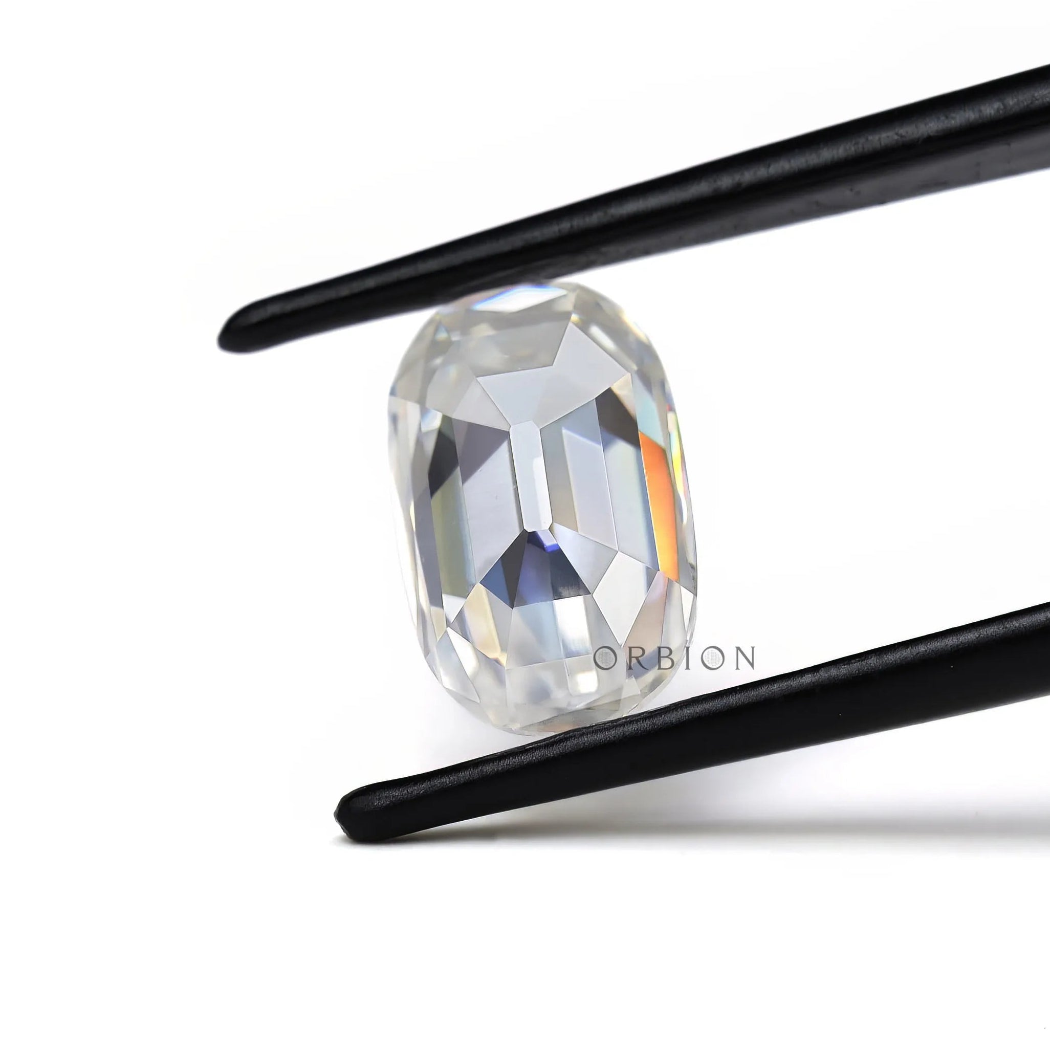 elongated cushion old mine cut moissanite held in tweezer showing side profile