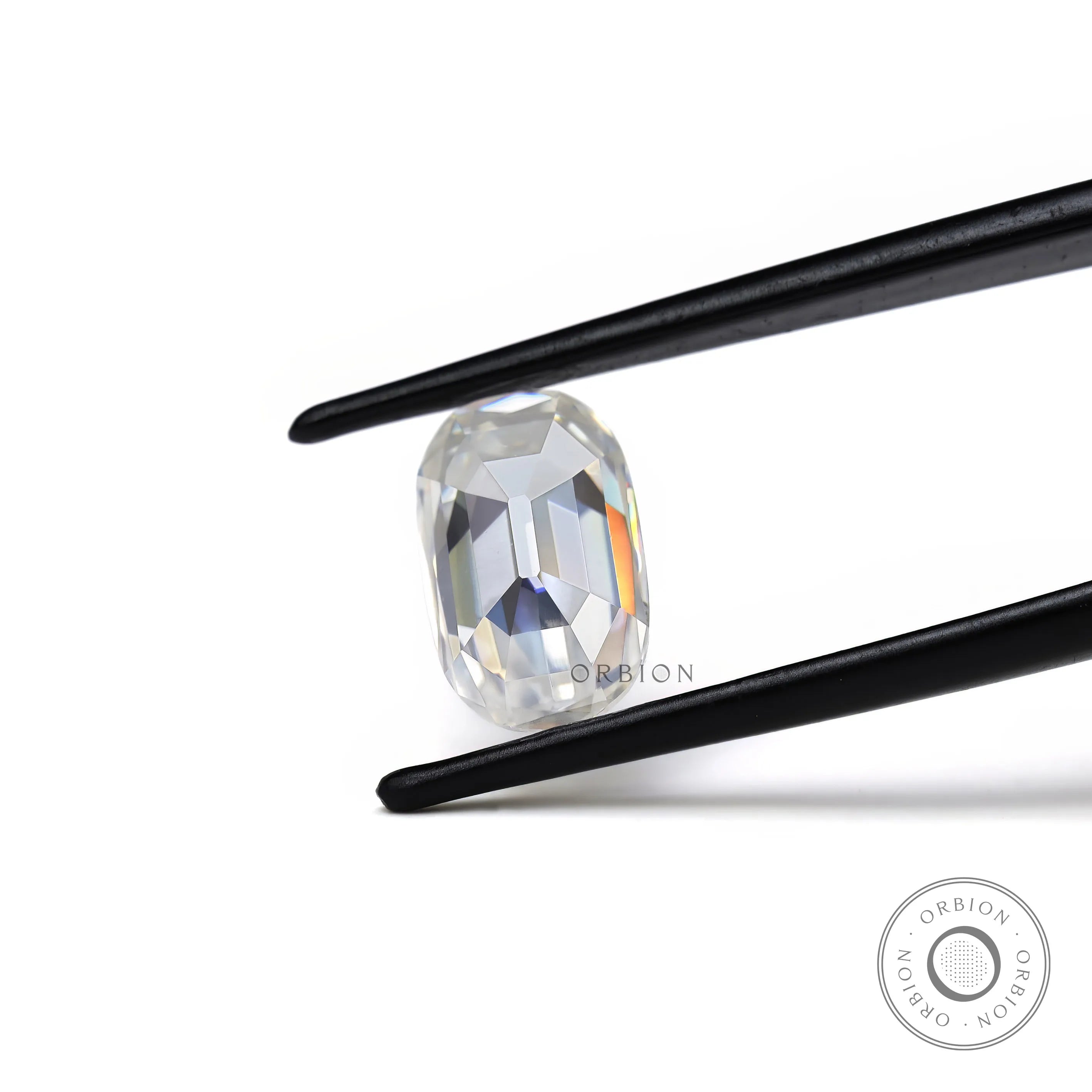 elongated cushion old mine cut moissanite held in tweezer showing side profile