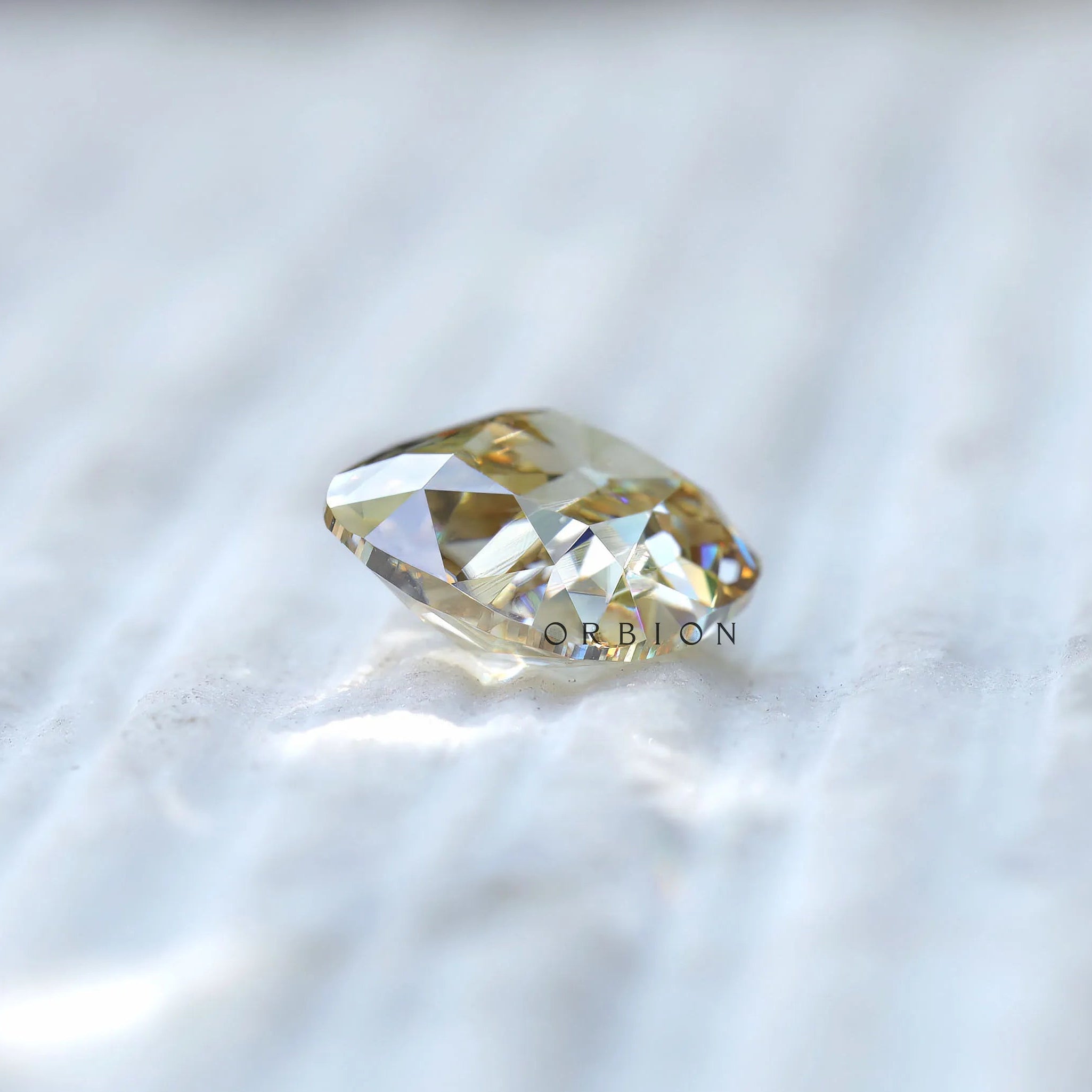 Side profile of yellowish moissanite showing depth and cut structure
