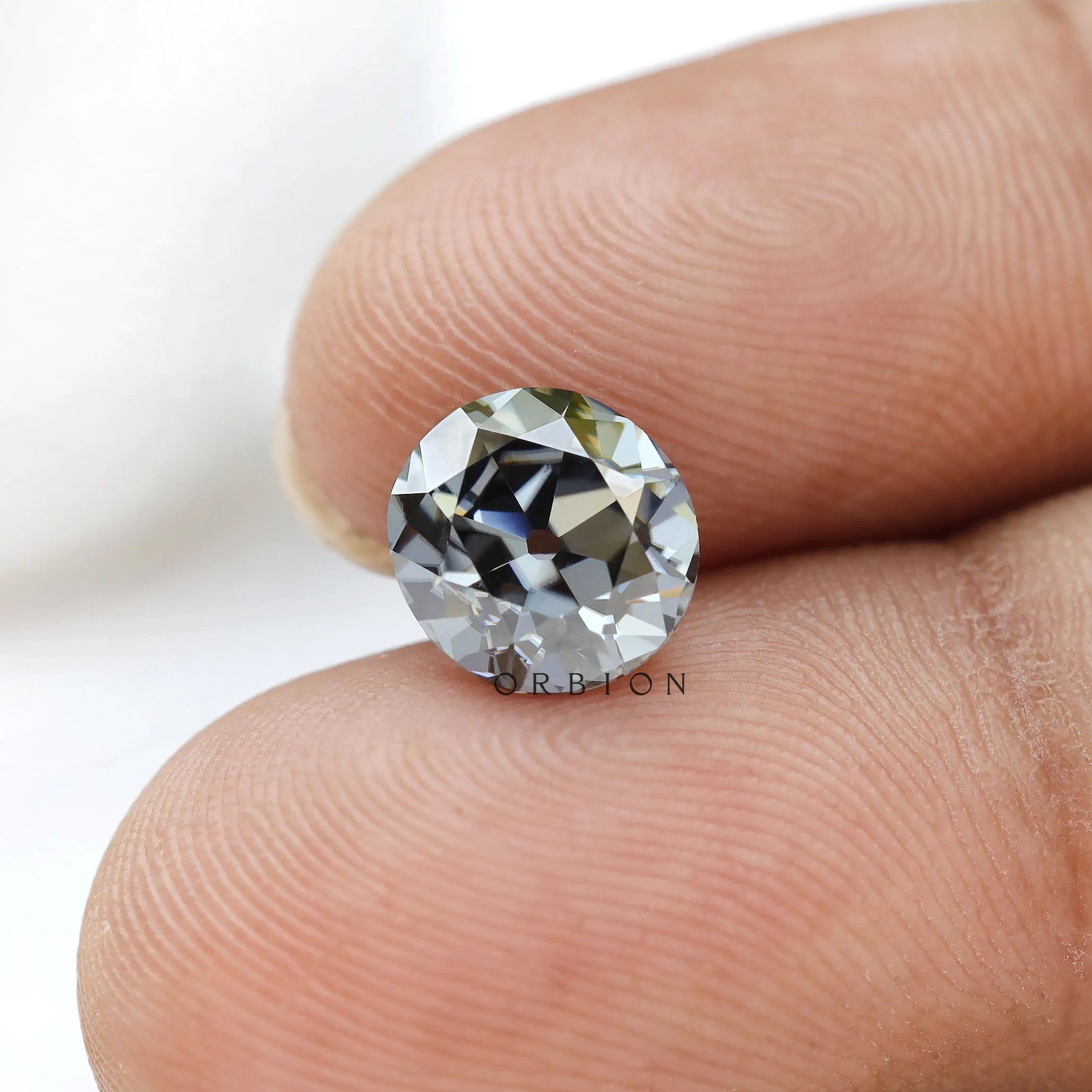 1.50 ct old european cut round dark grey moissanite loose stone, angled view