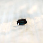 Step cut Old Mine emerald moissanite with deep tone reflection