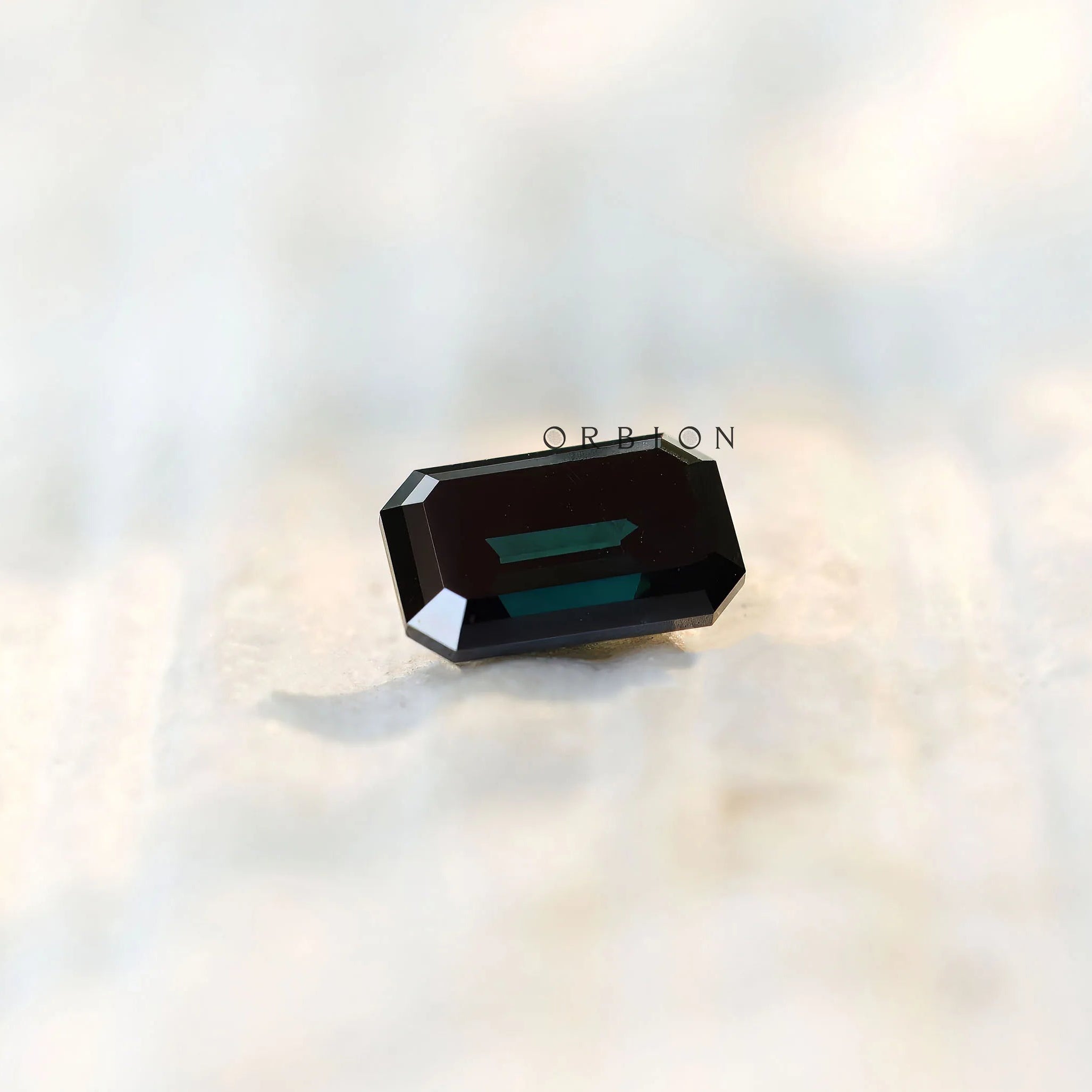 Step cut Old Mine emerald moissanite with deep tone reflection