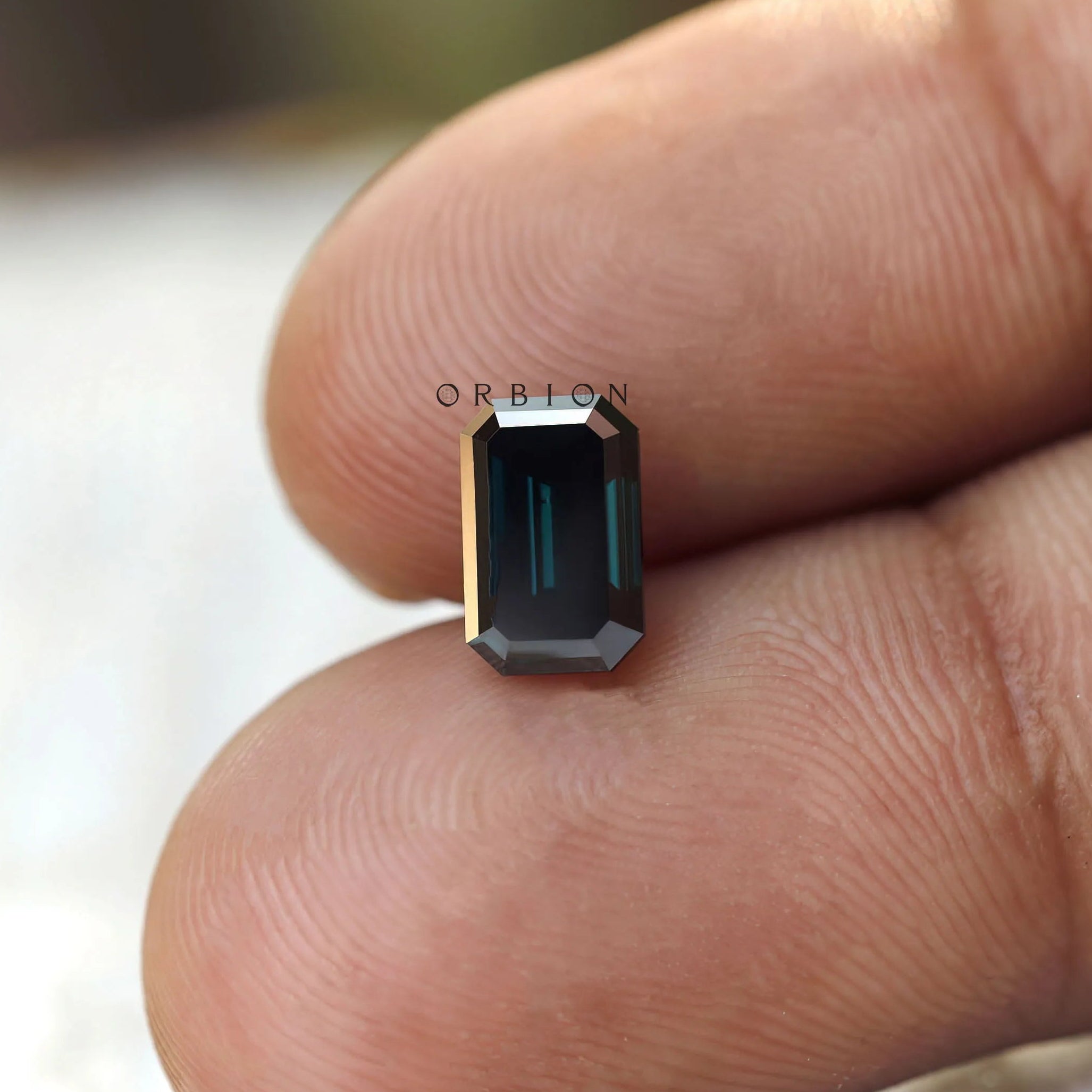 Loose emerald moissanite stone with reflective step facets