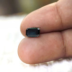 Emerald cut moissanite dark tone loose gemstone macro shot